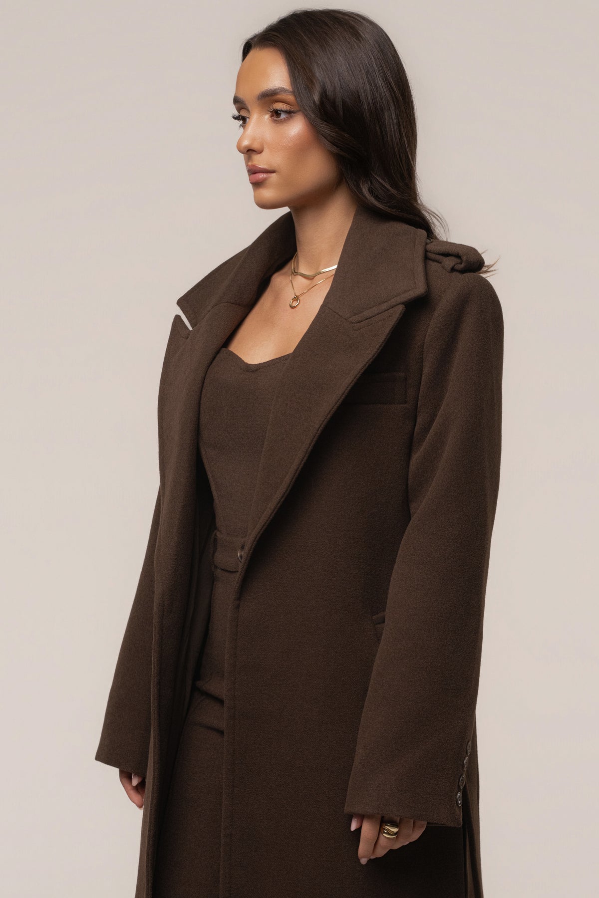 JLUXLABEL Chocolate Savannah belted coat, stylish outerwear with a tailored fit and belt, displayed on a hanger.