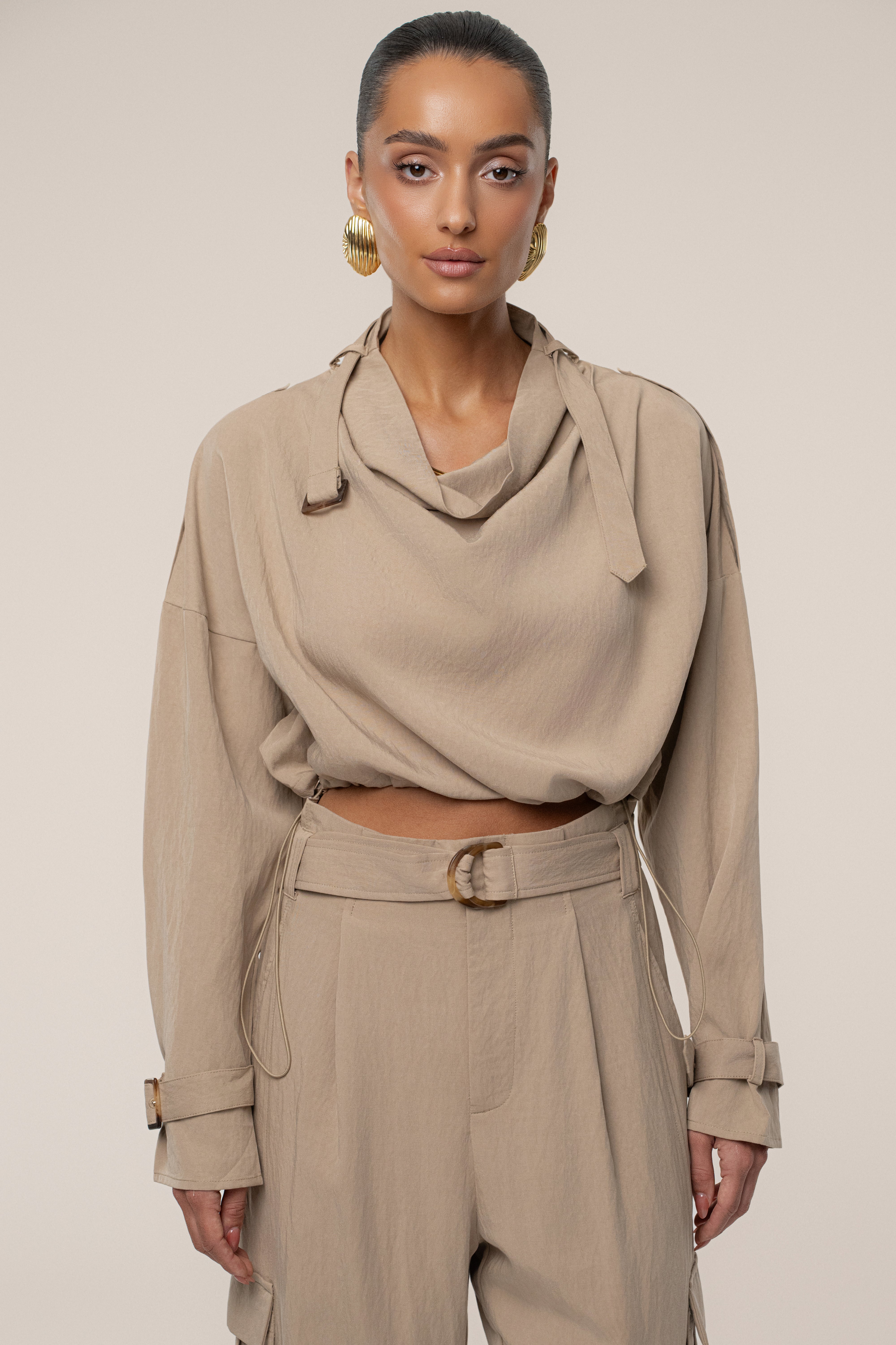 Beige JLUXLABEL Wanderlust crop top with sleeveless design and round neckline, styled on a model.