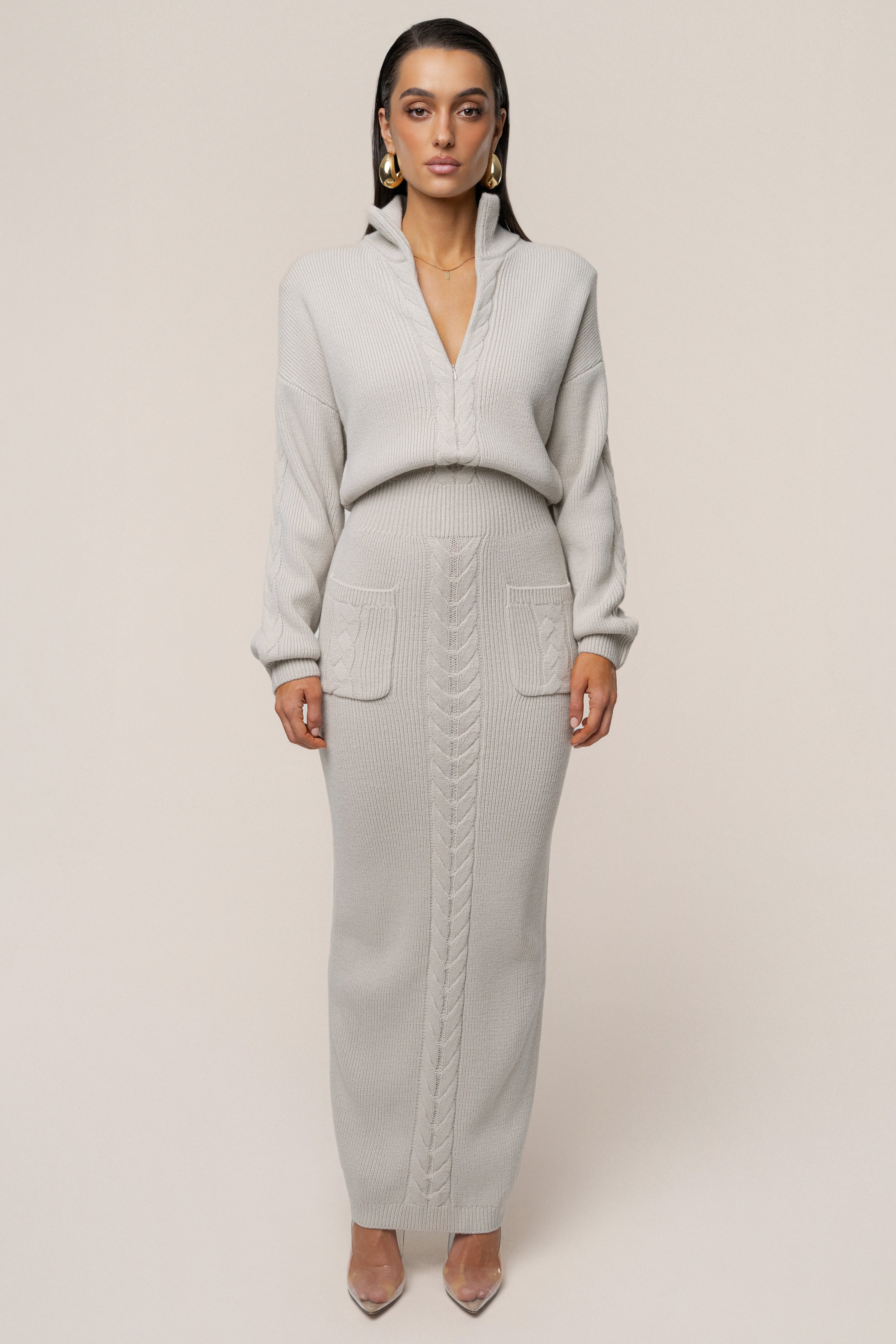 Stone-colored ribbed dress from JLUXLABEL showcasing a fitted silhouette and cozy, textured fabric.