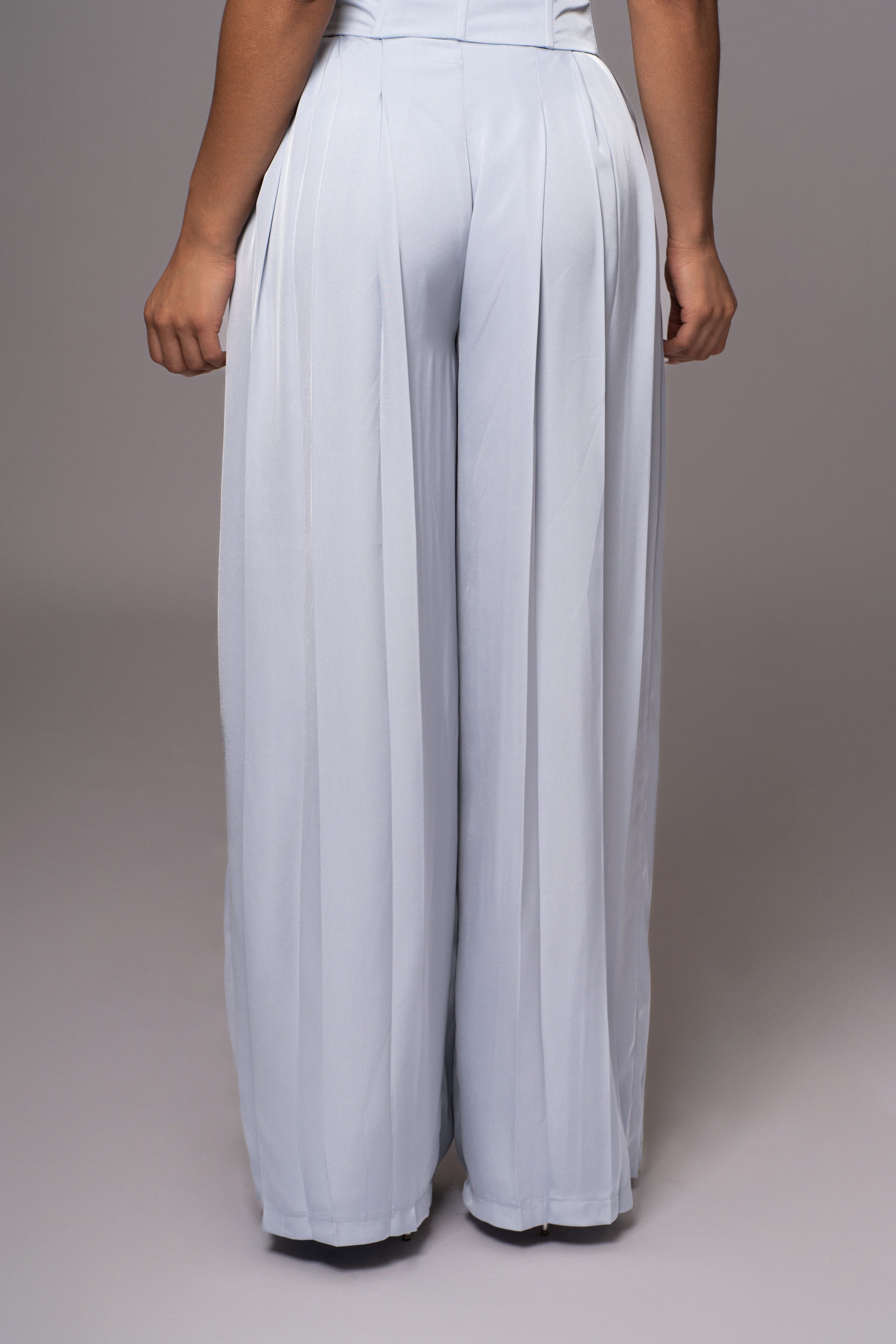 Blue Clara wide-leg pleated trousers from JLUXLABEL, shown styled with a casual top, featuring a relaxed fit and high waist.