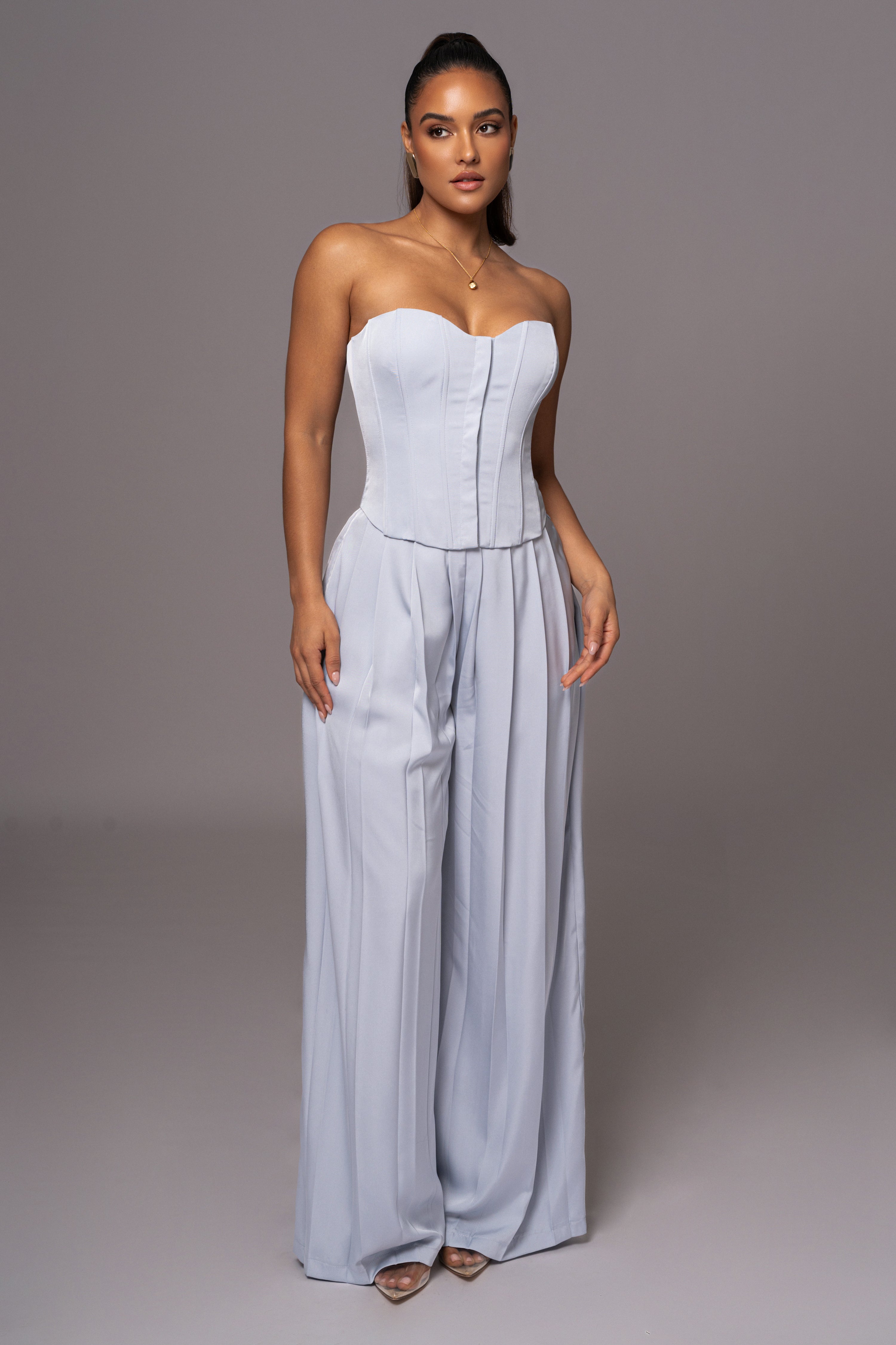Blue Clara wide-leg pleated trousers by JLUXLABEL, shown styled with a casual top and sneakers on a model.