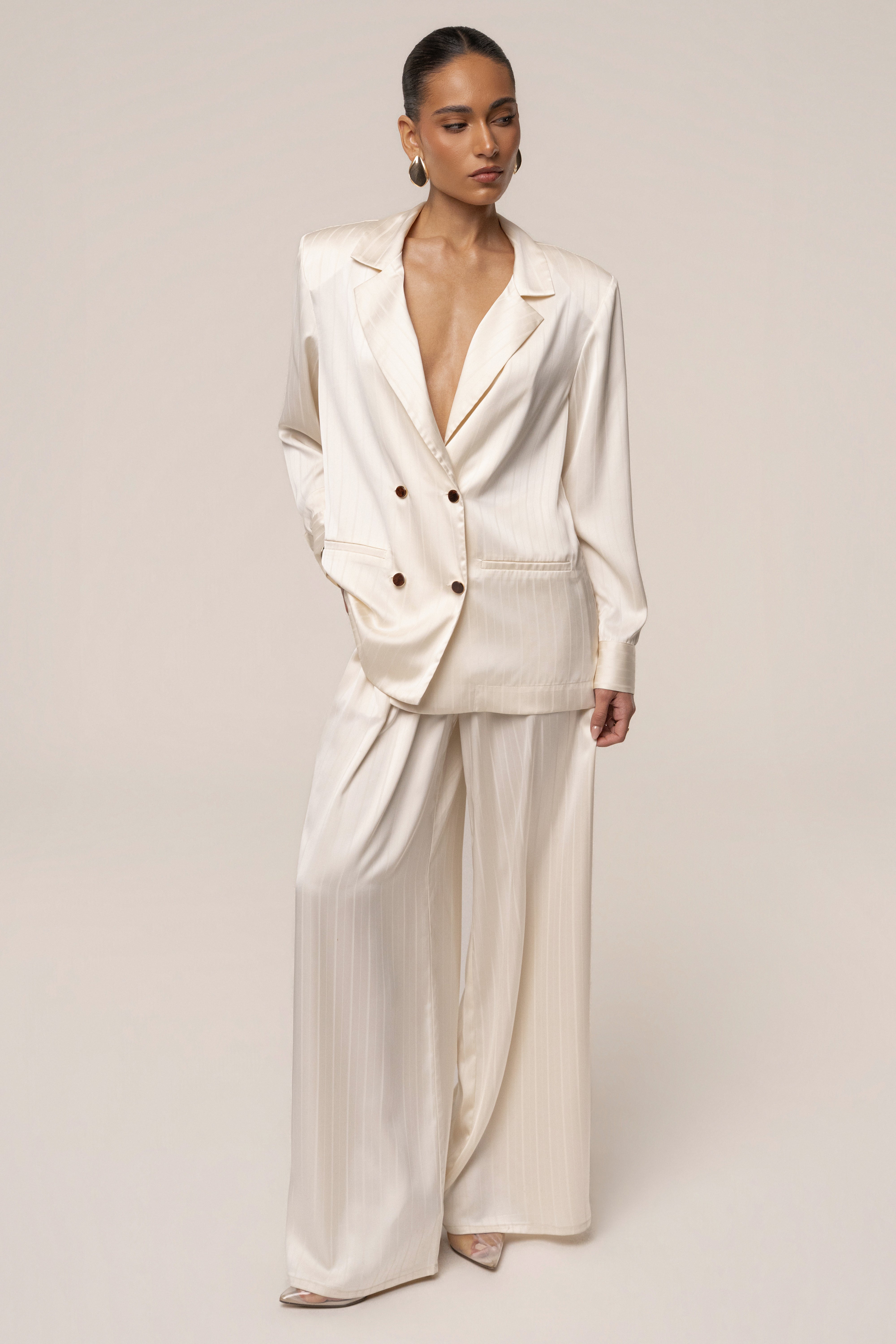 Ivory JLUXLABEL The Standard blazer shown on a hanger, featuring a tailored fit and classic lapel for stylish tops.