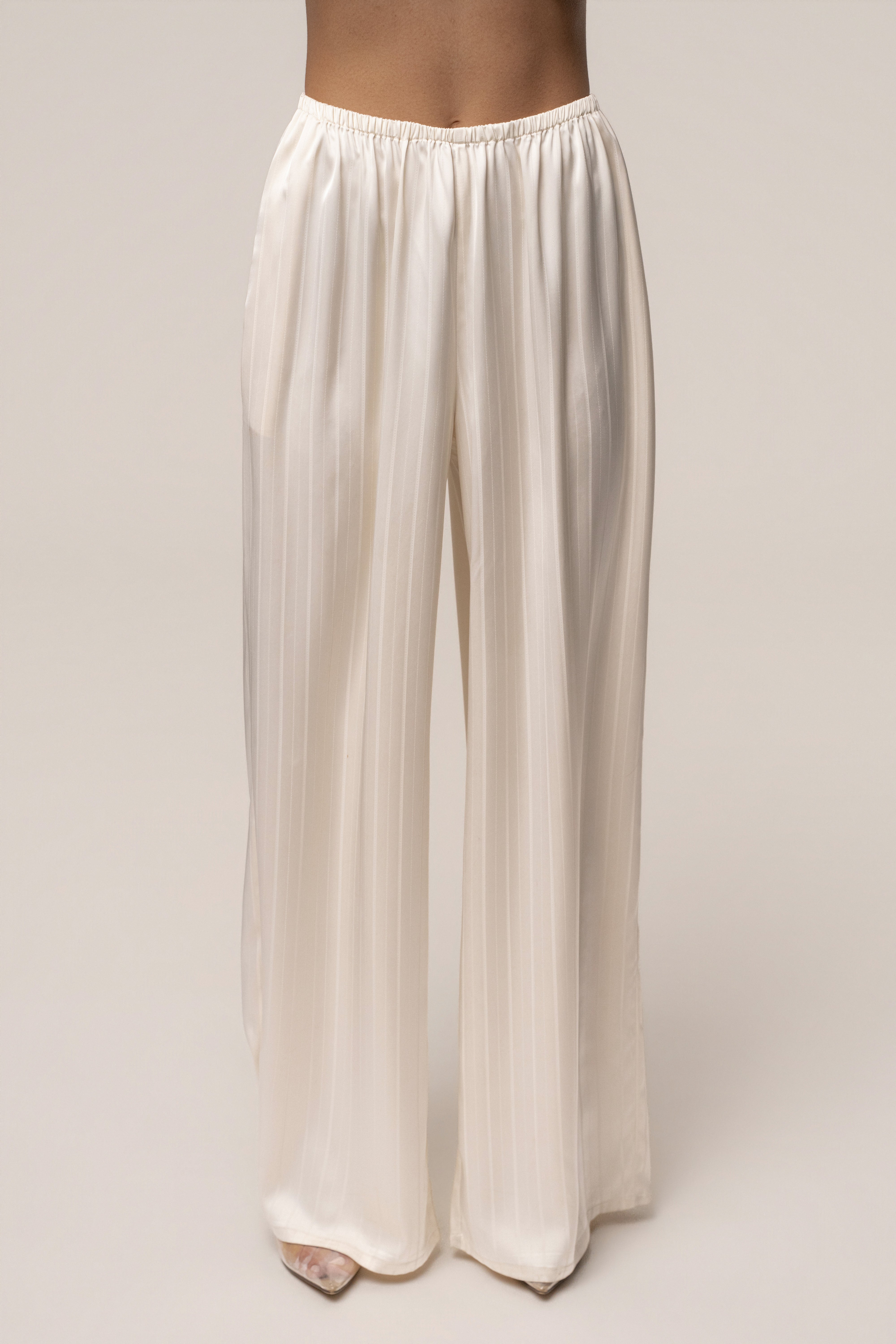 Ivory JLUXLABEL The Standard Pant, stylish bottoms with a tailored fit, showcased on a model in a fashion-forward outfit.