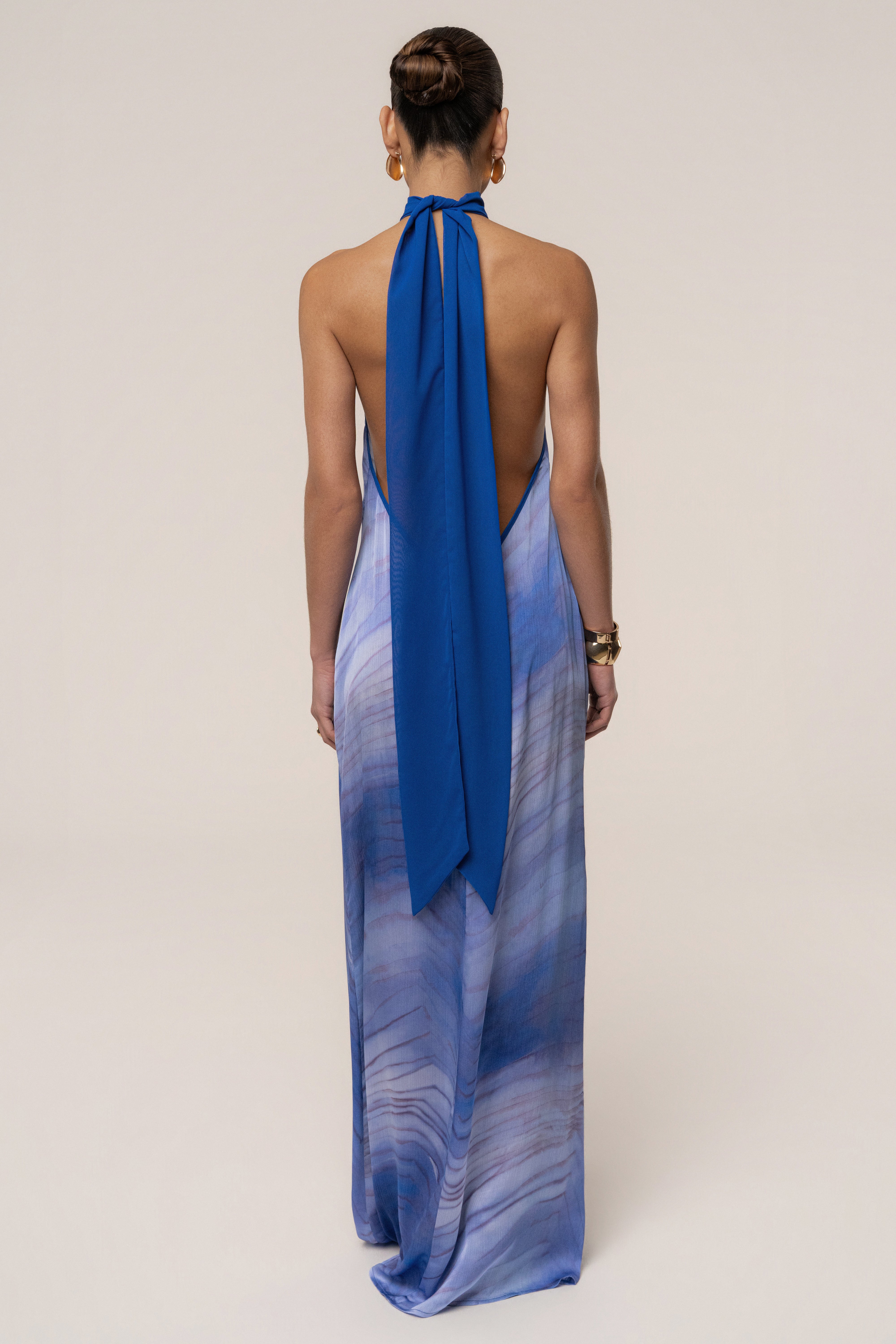 Blue Sunset Waves Maxi Dress by JLUXLABEL featuring flowing fabric and vibrant wave-inspired pattern.