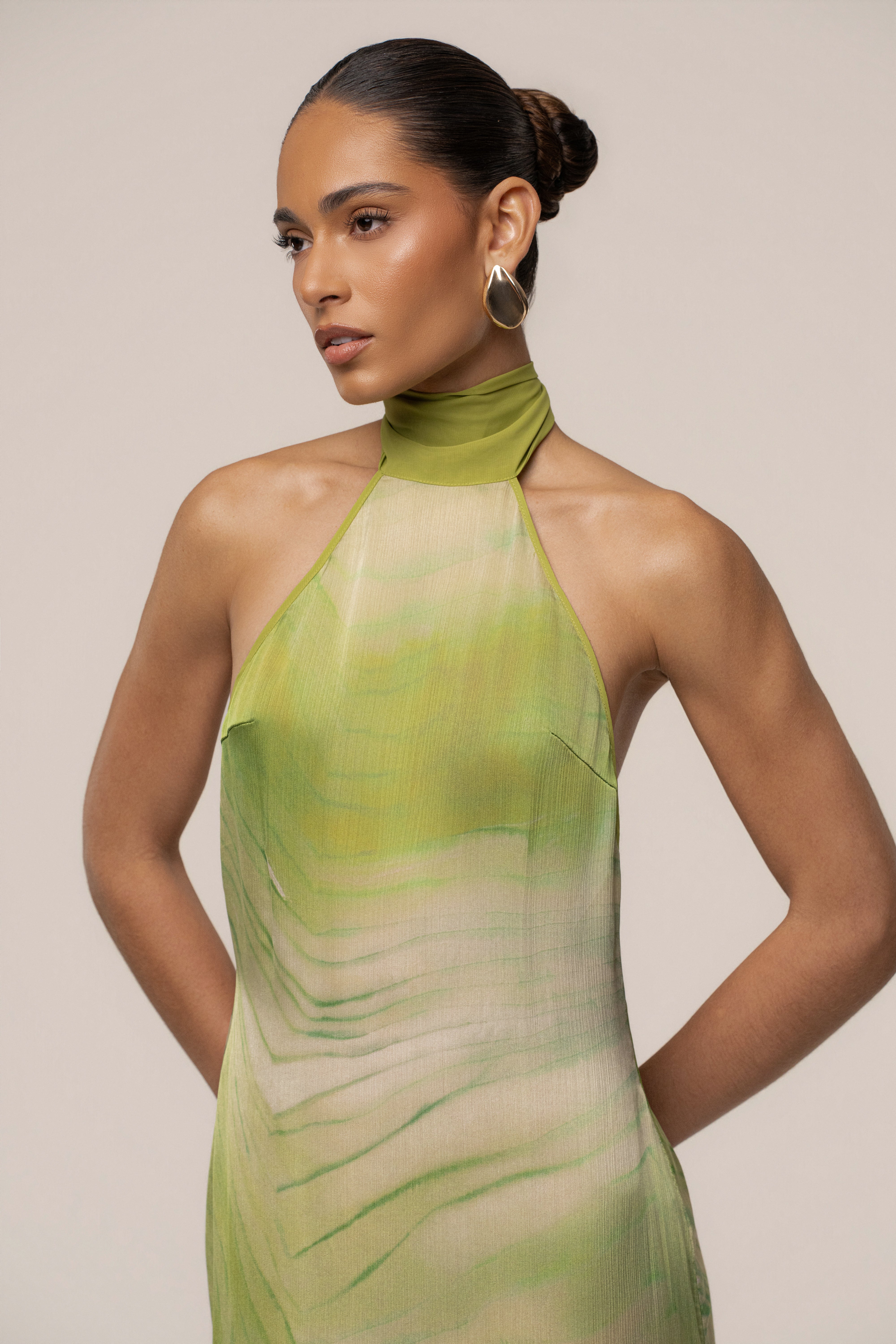 Green Sunset Waves maxi dress by JLUXLABEL, featuring flowing fabric and vibrant wave pattern, perfect for summer or beach wear.