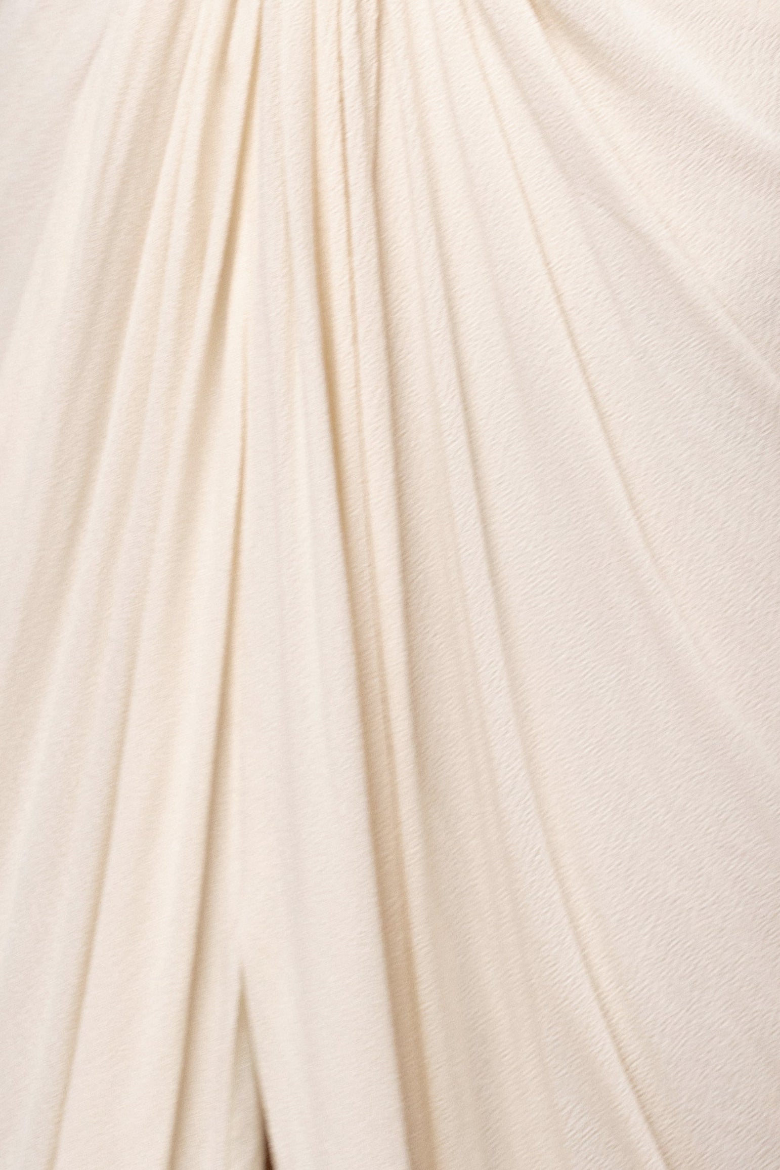 Cream Warm Sunsets Maxi Dress by JLUXLABEL featuring flowy fabric and a relaxed fit, shown on a model with a sunset background.