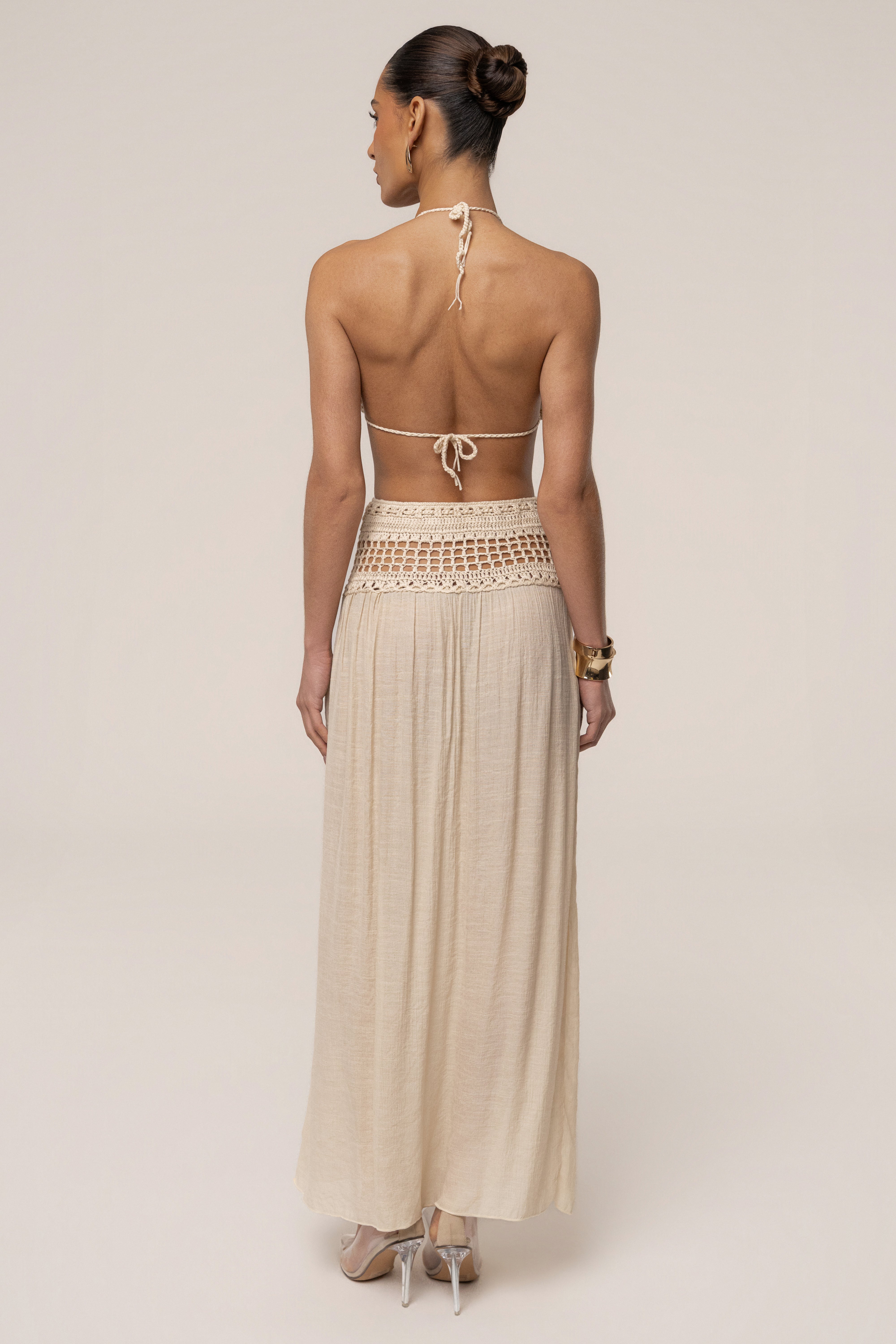 Beige JLUXLABEL crochet maxi skirt with a flowing design, perfect for resort wear, shown on a model.