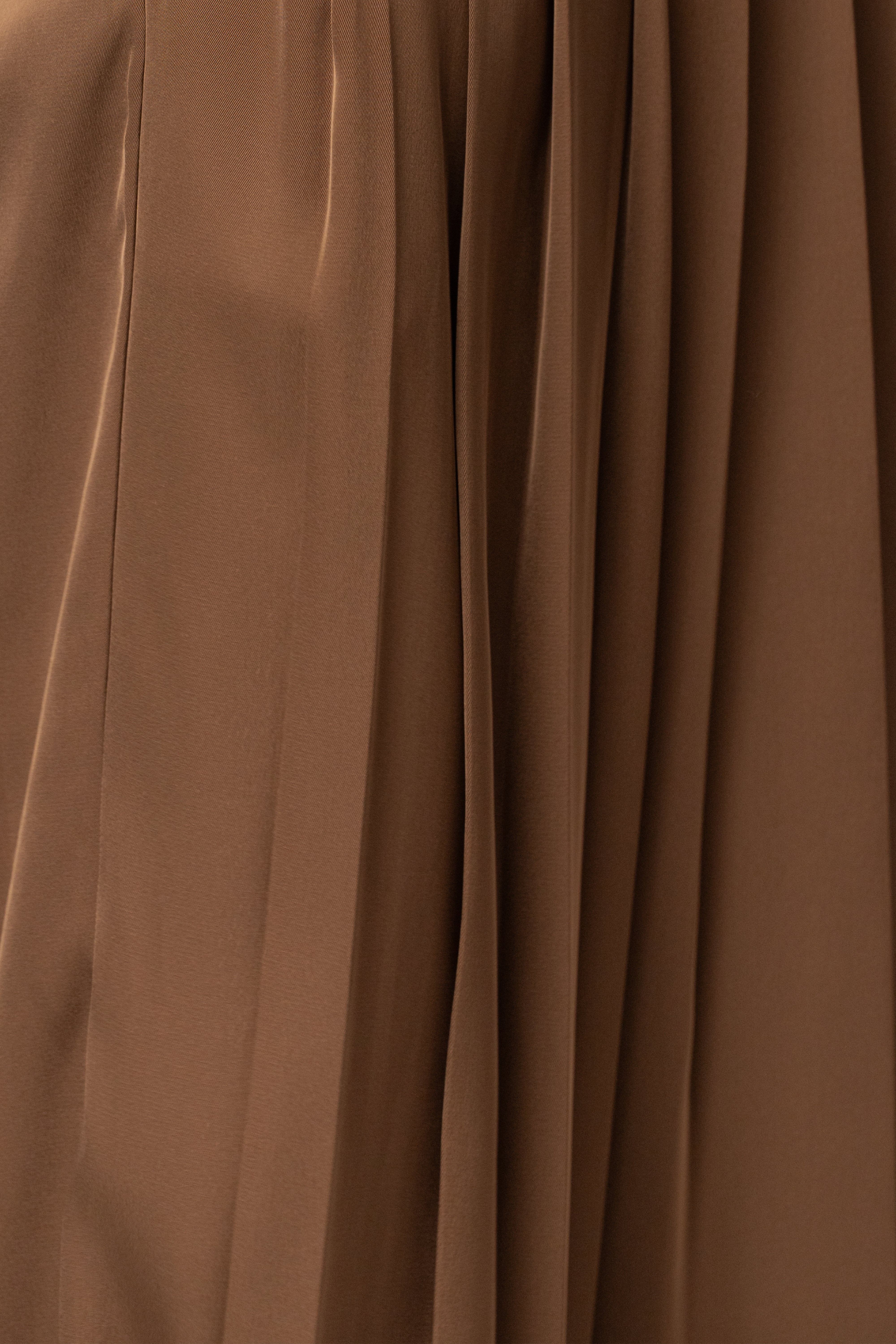 Brown Clara wide-leg pleated trousers by JLUXLABEL, showing the flowy, high-waisted bottoms with pleats and relaxed fit.
