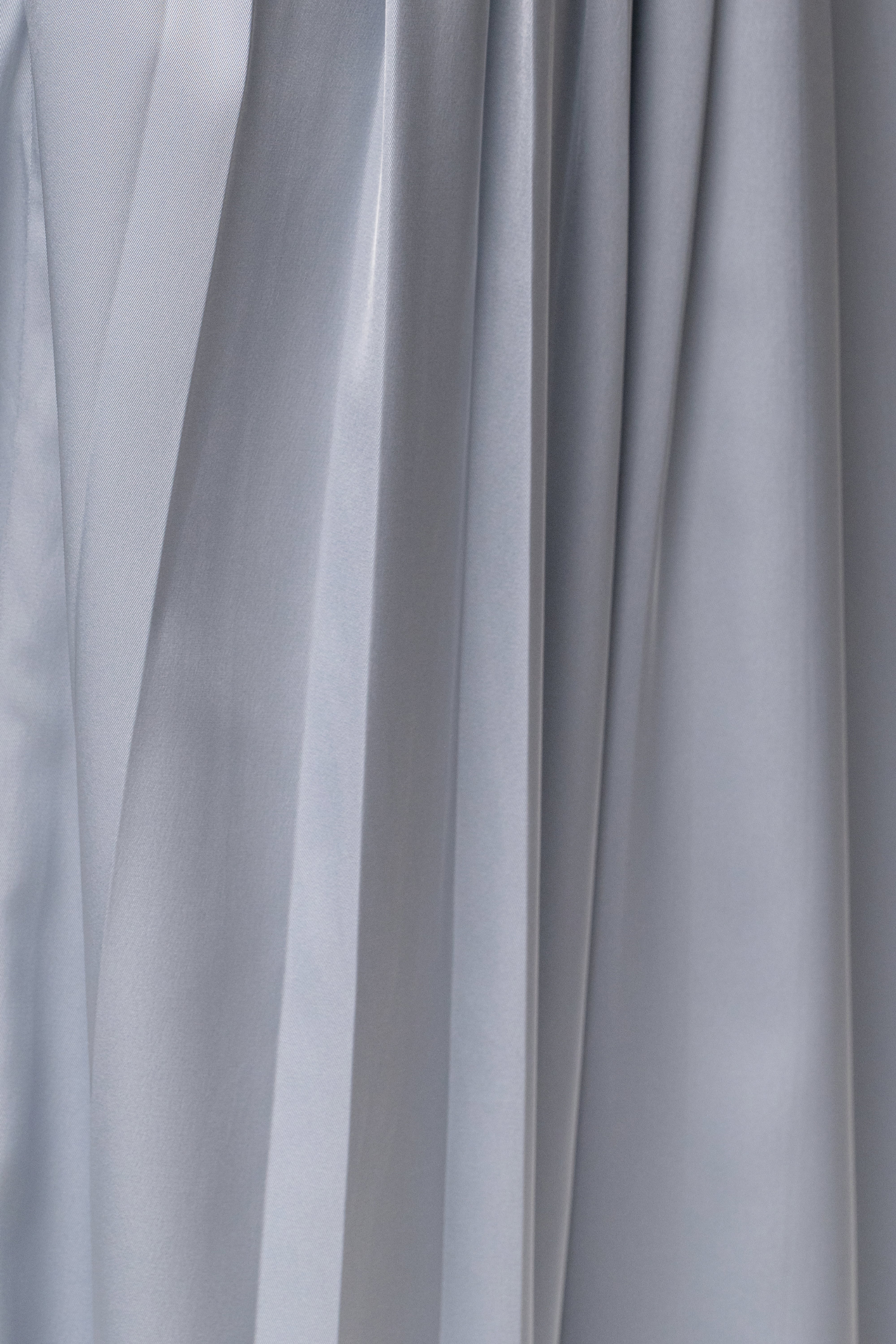 Blue Clara wide leg pleated trousers by JLUXLABEL, featuring a relaxed fit, high waist, and flowing fabric, styled on a model.