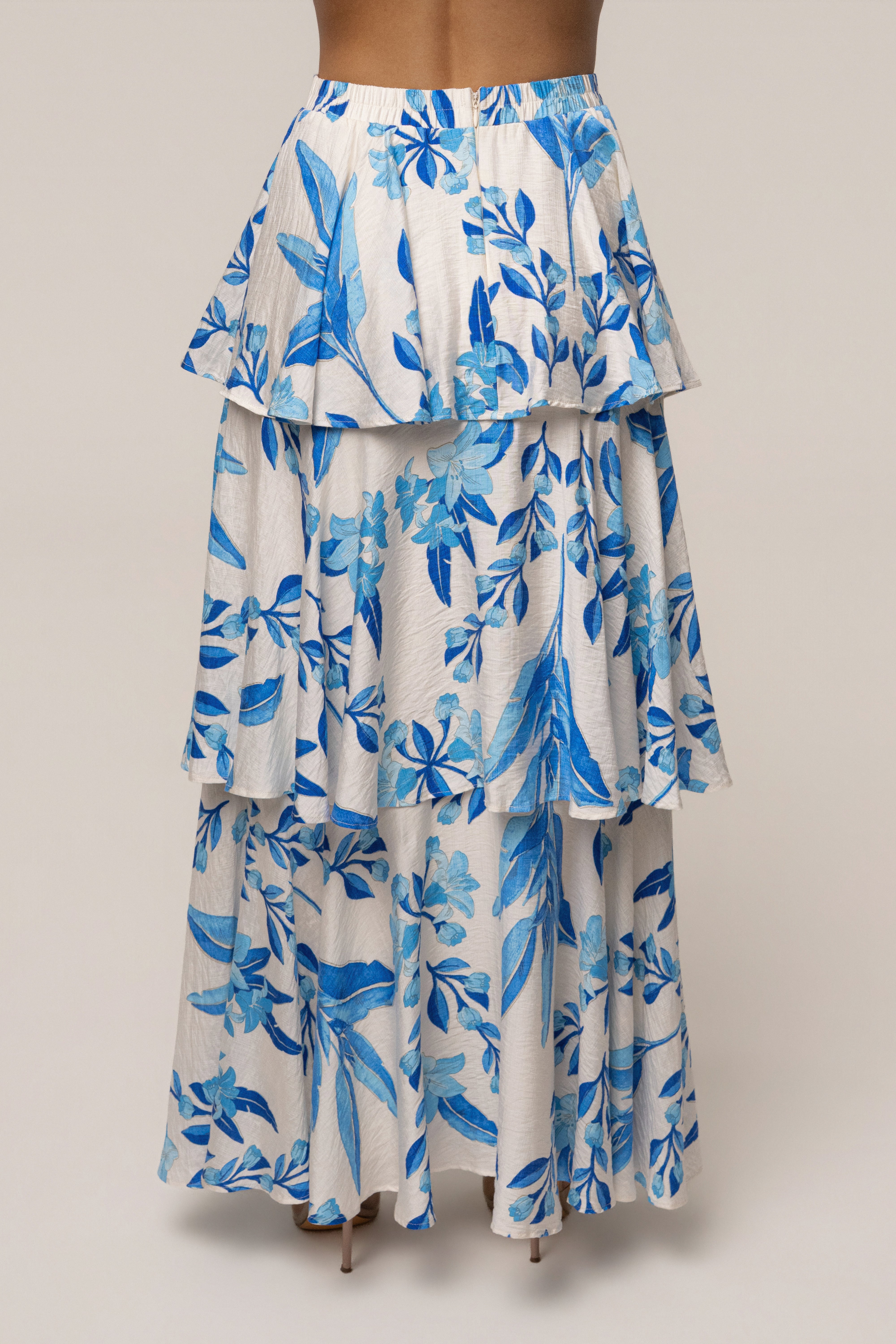 Blue floral Jasmine ruffle maxi skirt from JLUXLABEL, flowing fabric with ruffle details, perfect for a boho-chic look.