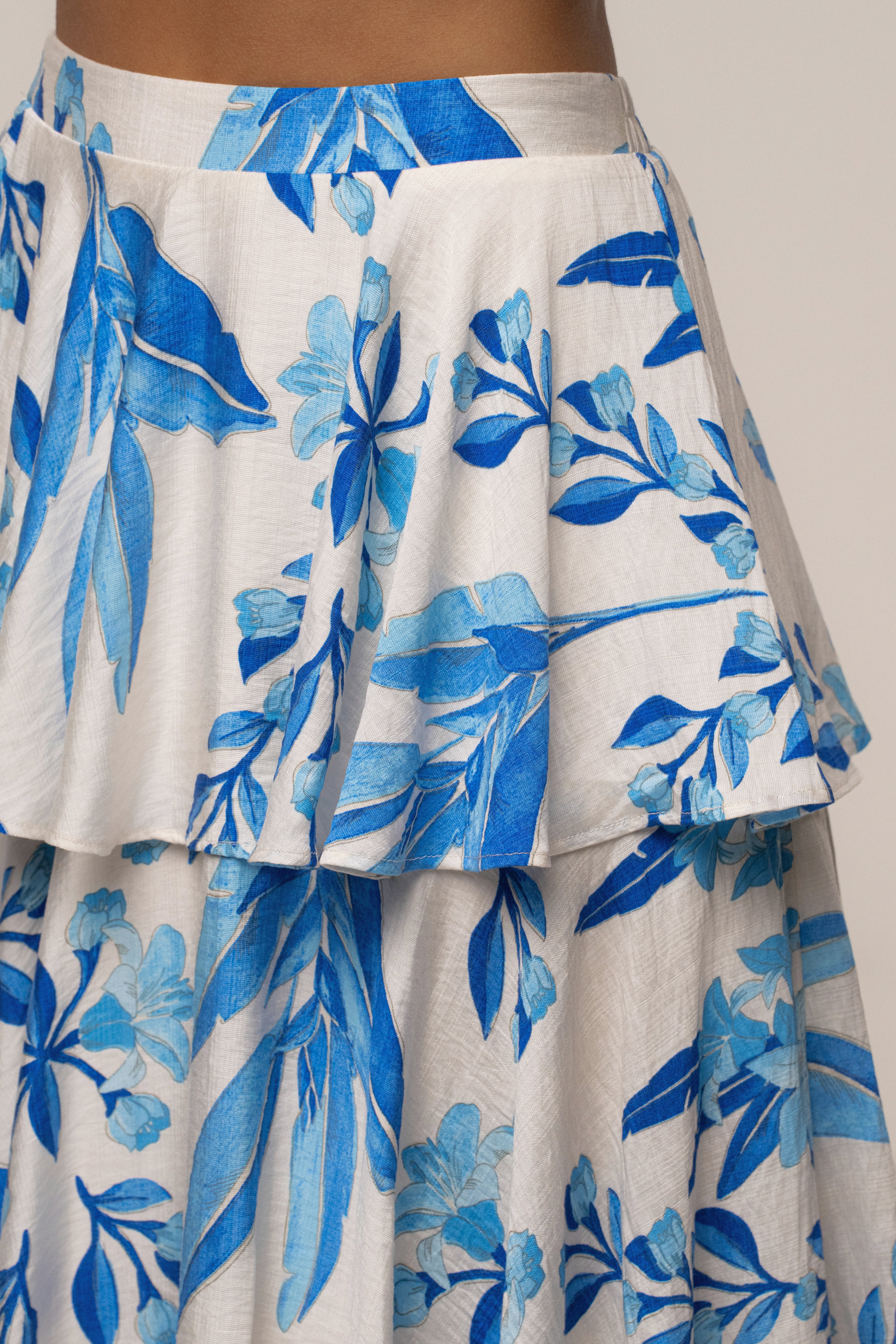 Blue floral Jasmine ruffle maxi skirt by JLUXLABEL, flowing design with ruffle details, perfect for stylish summer looks.
