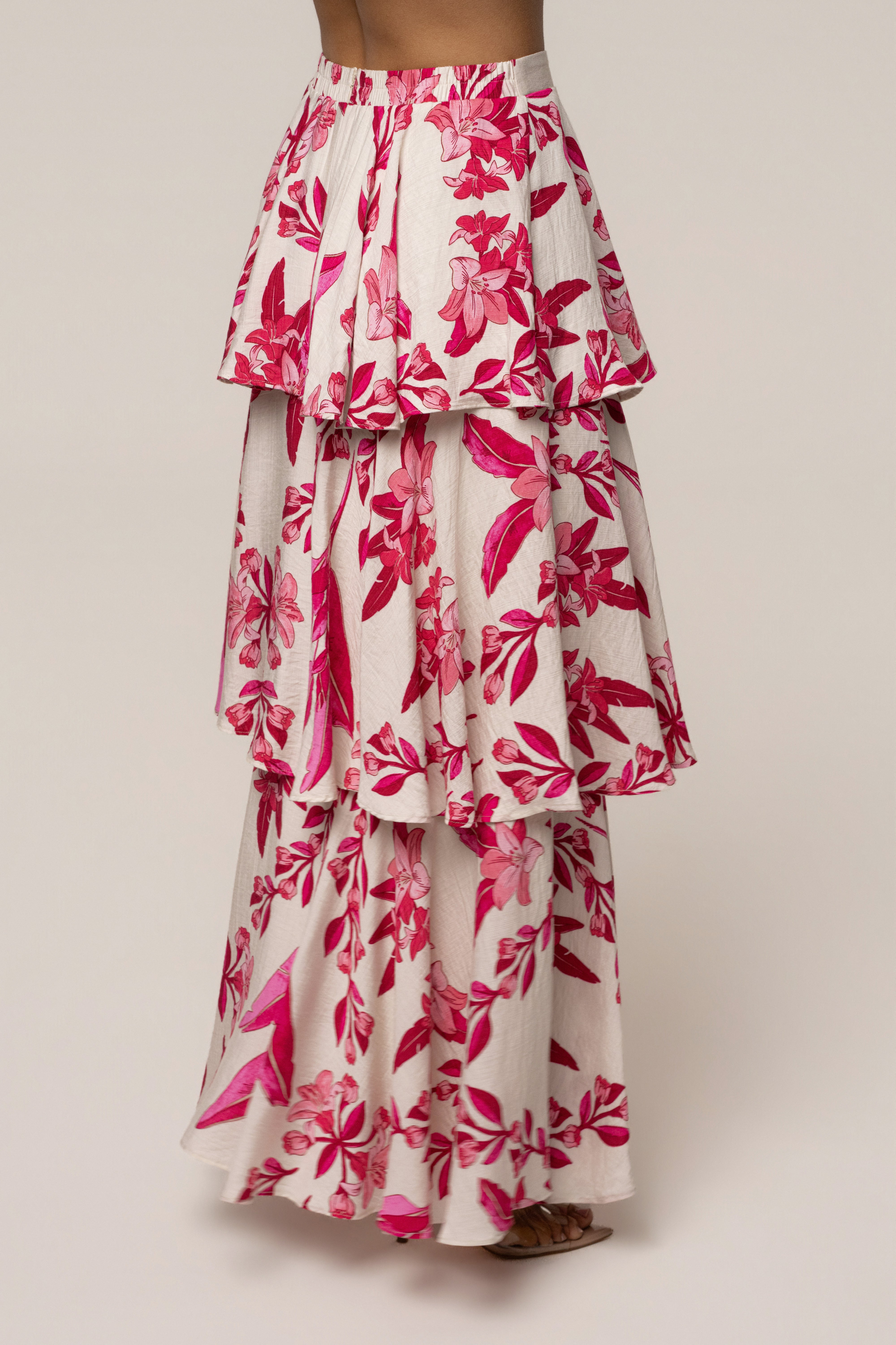 Pink floral jasmine ruffle maxi skirt from JLUXLABEL featuring flowy fabric, ruffled hem, and floral print for a feminine look.
