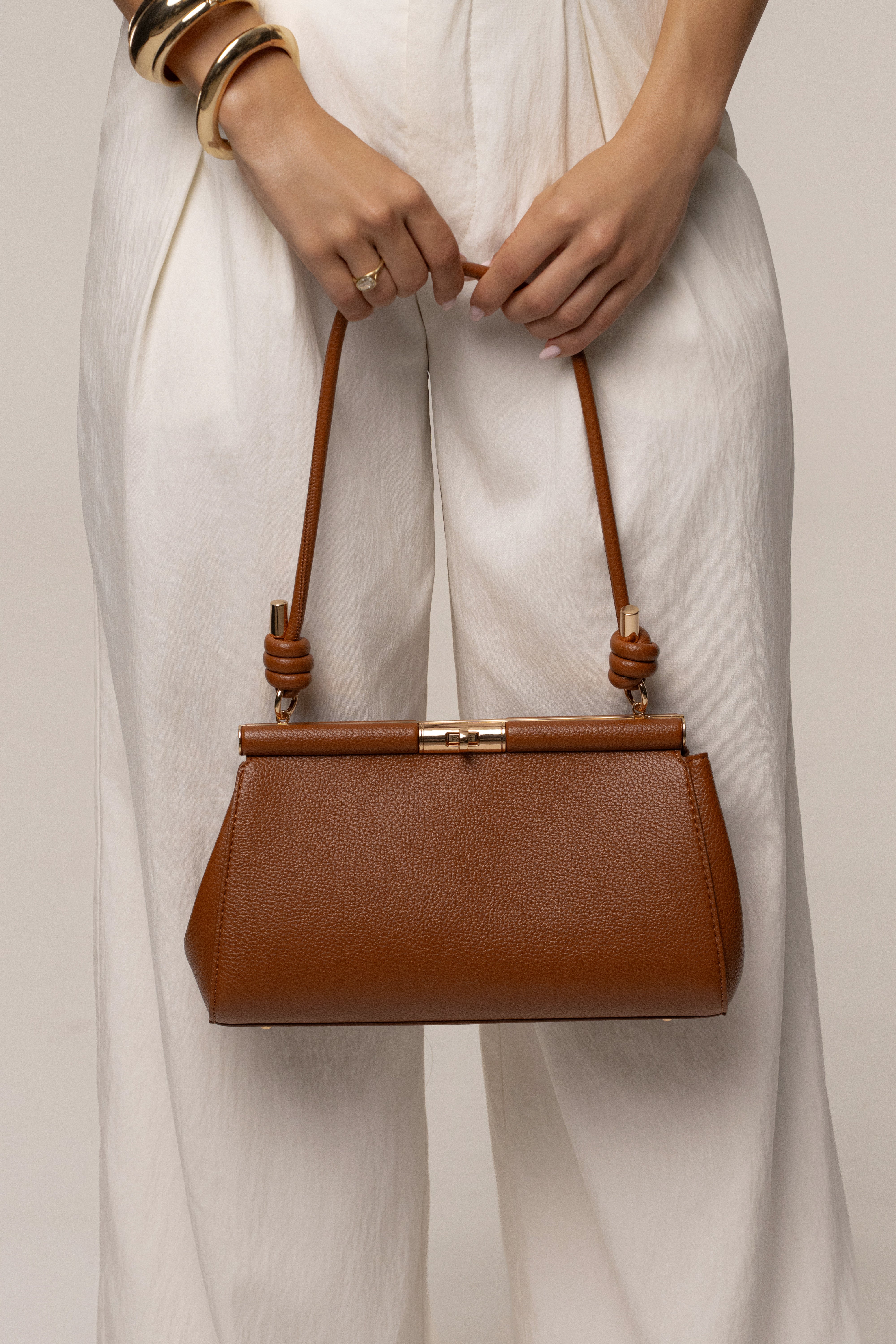 Brown Irene handbag by JLUXLABEL, stylish accessories with a structured design and top handle, shown in a close-up image.