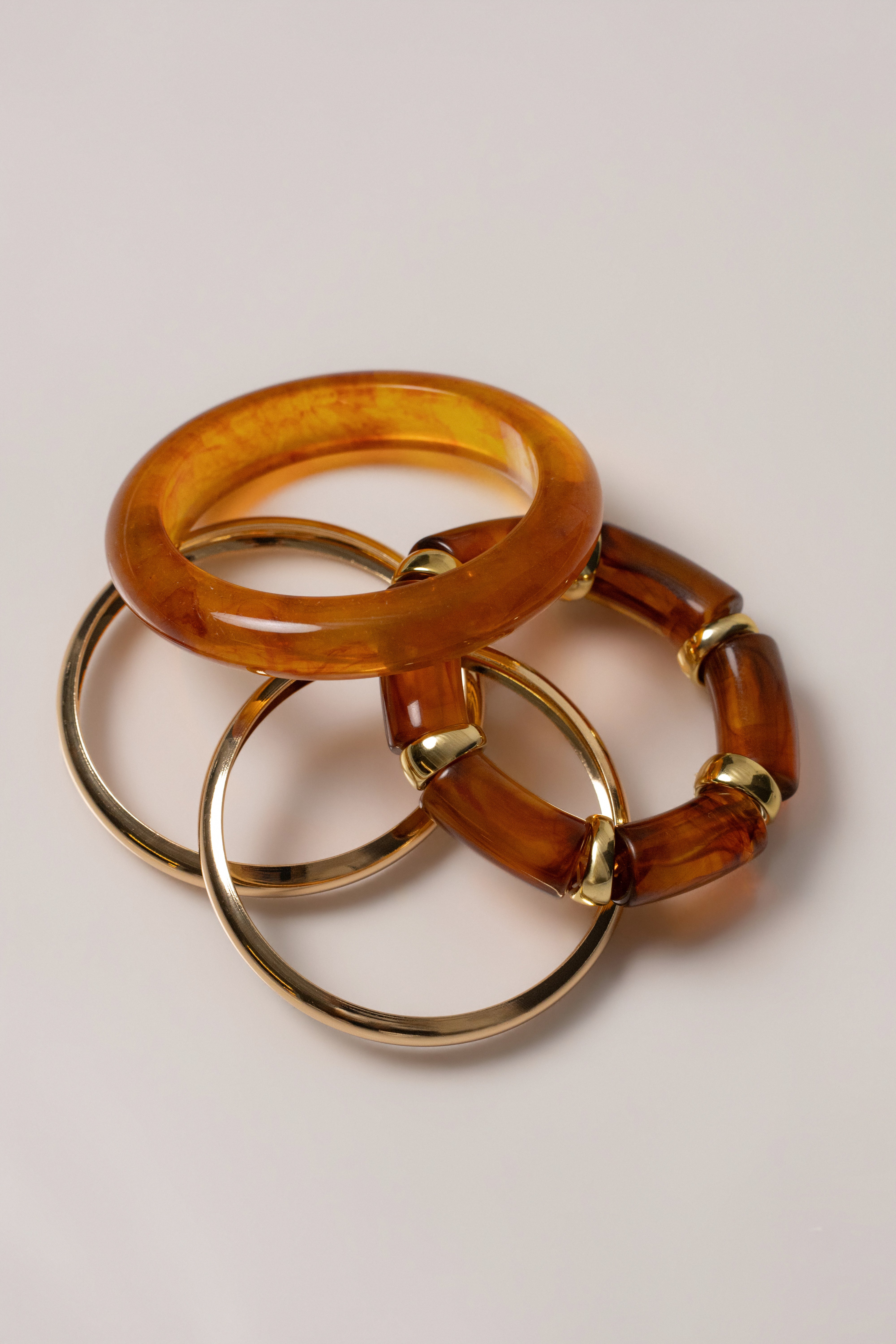 Gold vacation bracelet set from JLUXLABEL featuring layered jewelry with delicate chain and charm accents.