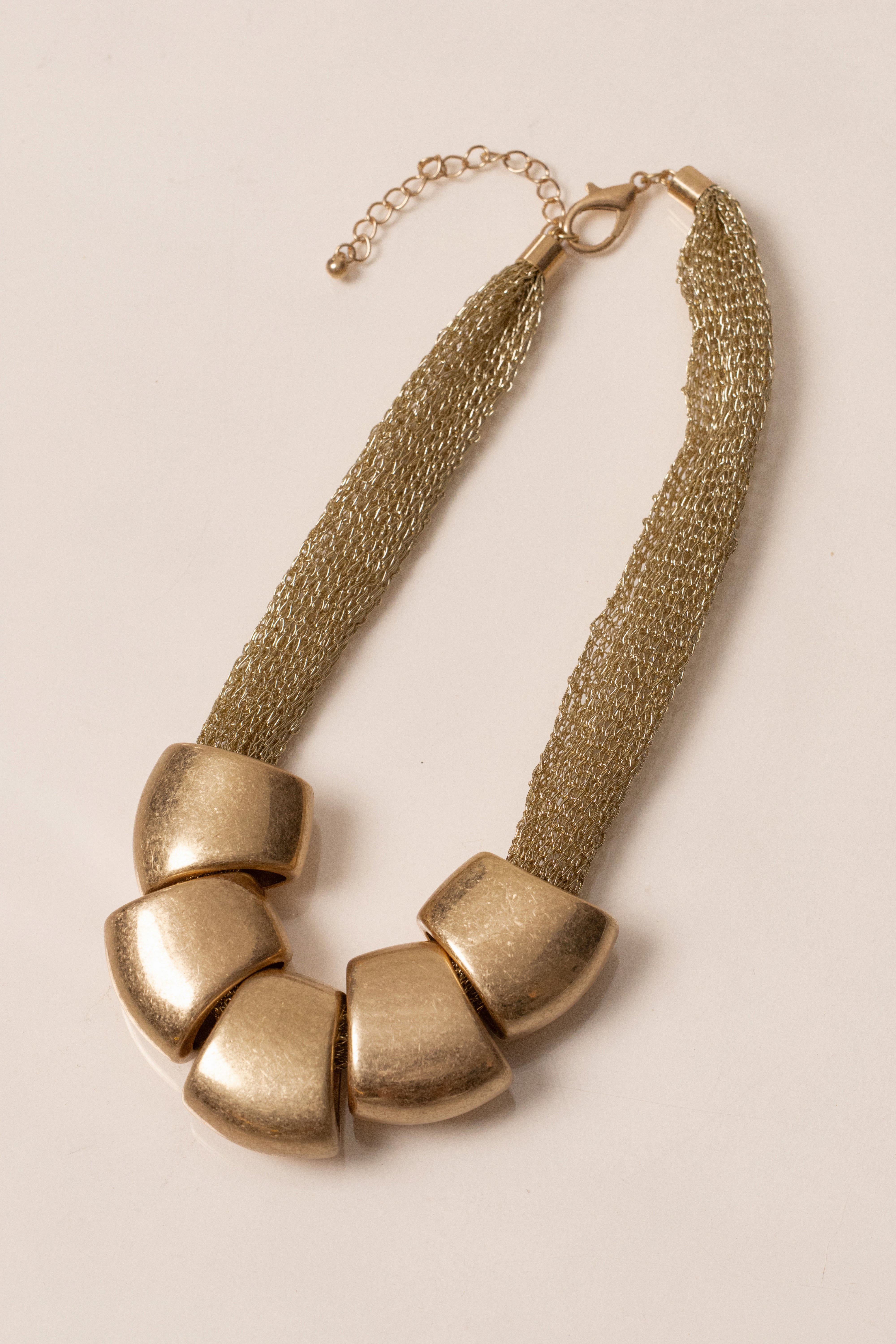 Gold Mila Pebble Necklace by JLUXLABEL featuring smooth, rounded pebble-shaped jewelry with a delicate chain.