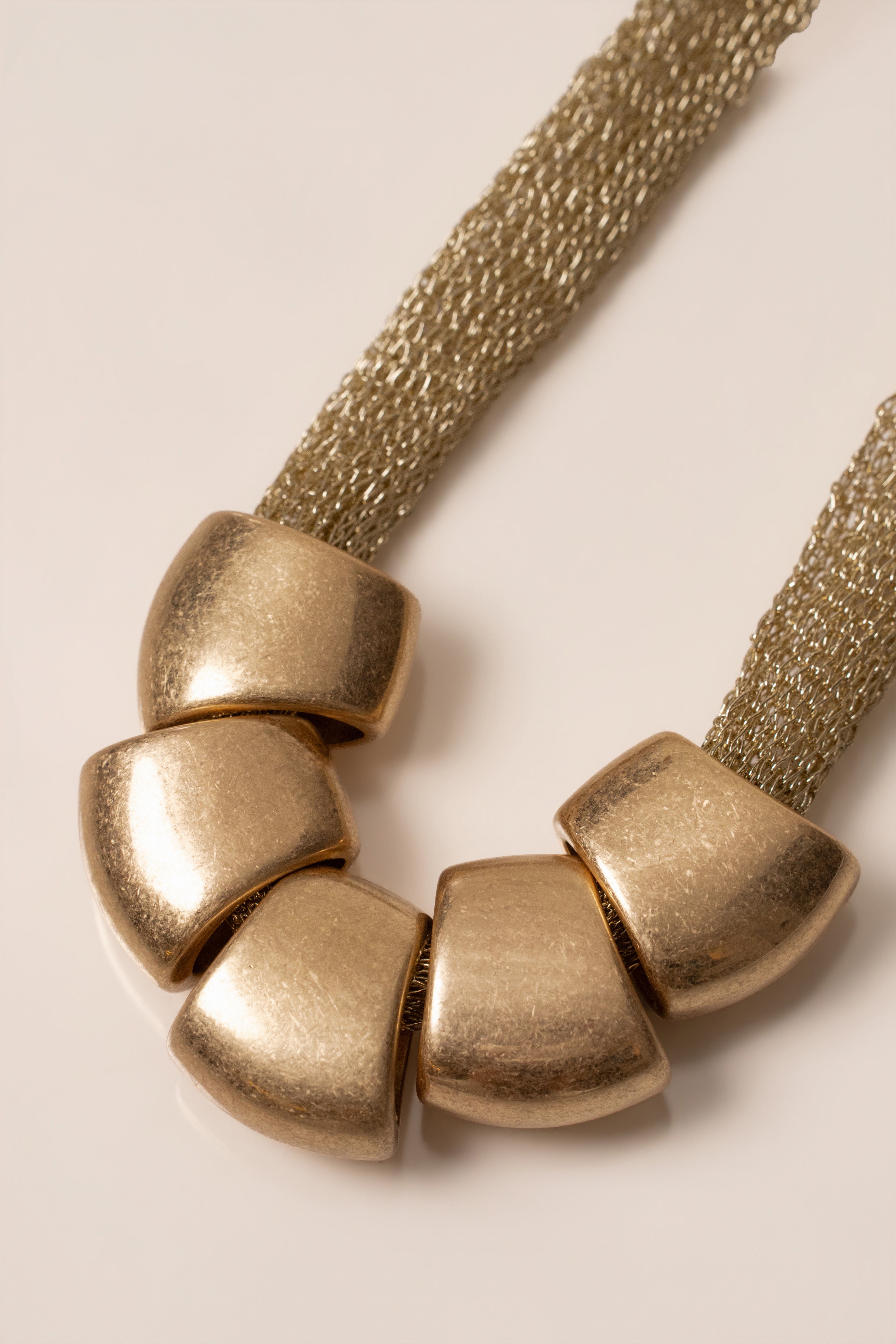 Gold Mila Pebble Necklace from JLUXLABEL featuring smooth pebble-shaped jewelry with a delicate chain.