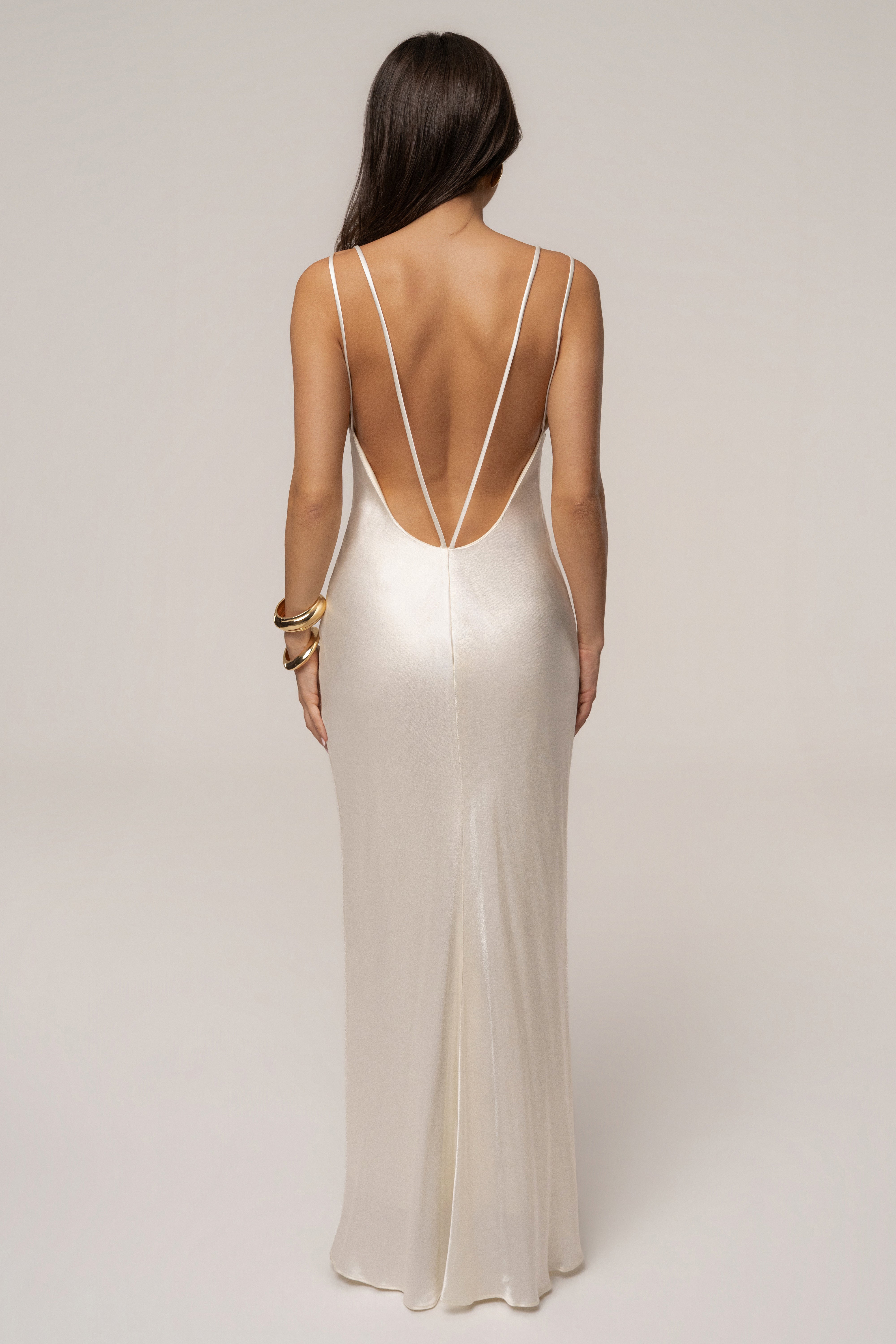 Ivory Promise Satin Maxi Dress by JLUXLABEL displayed on a hanger, showcasing its smooth satin fabric and elegant floor-length design.