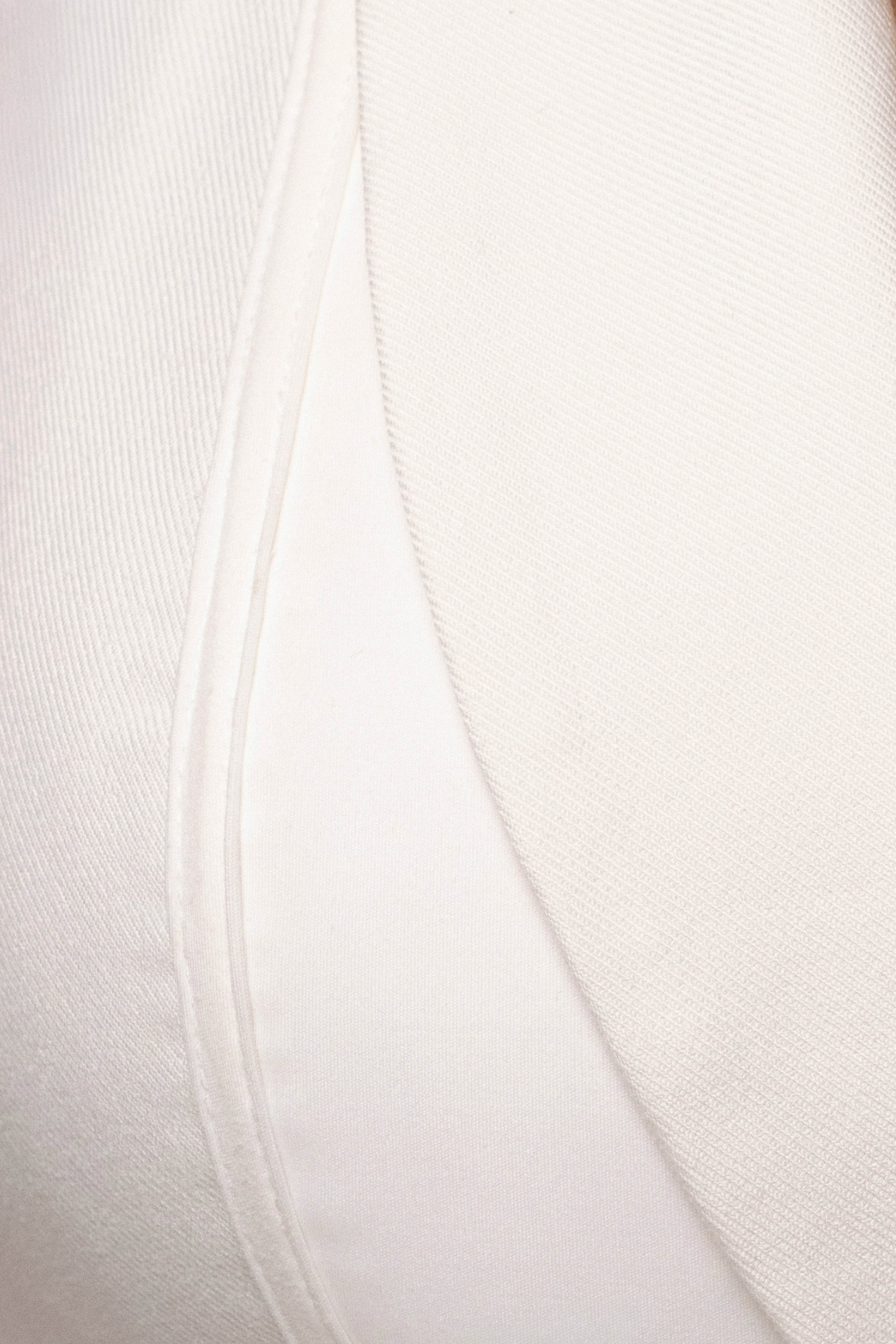 Cream contour corset bodysuit by JLUXLABEL, shown as a fitted top with structured design and adjustable straps.