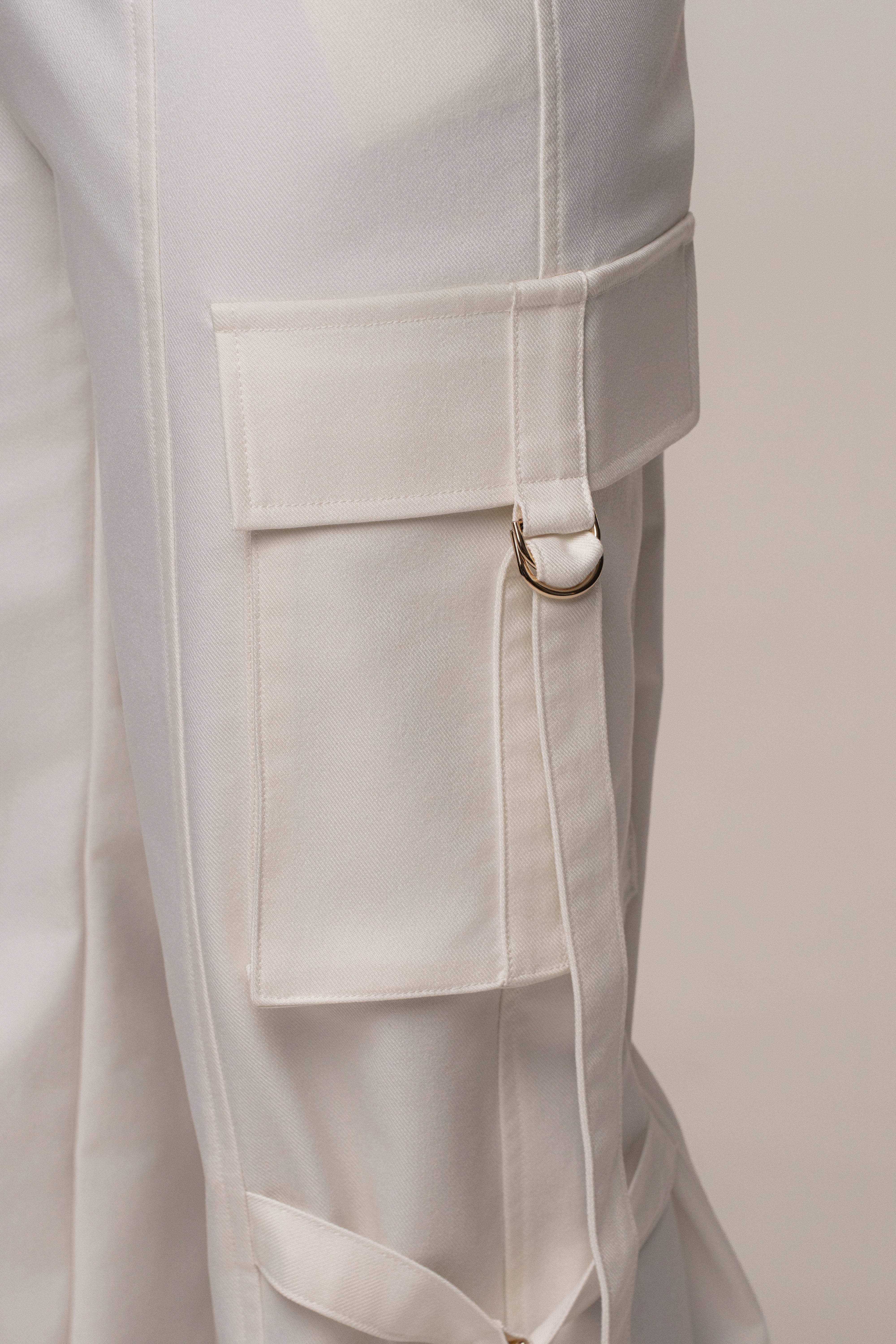 JLUXLABEL Cream Downtown Cargo Pant shown in a stylish casual bottoms design, featuring multiple pockets and a relaxed fit.
