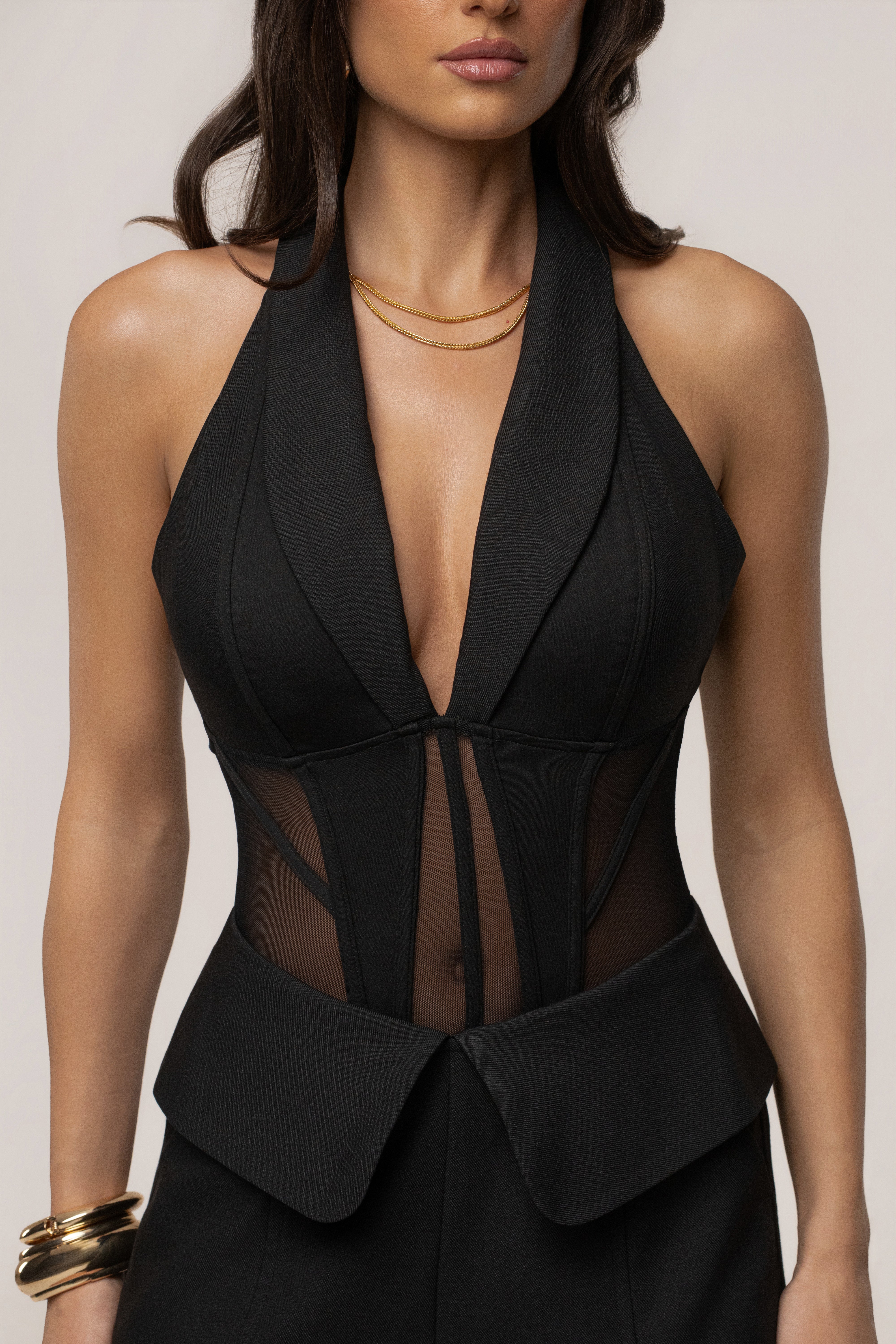 Black contour corset bodysuit by JLUXLABEL, form-fitting top with structured design and adjustable straps, shown on a model.