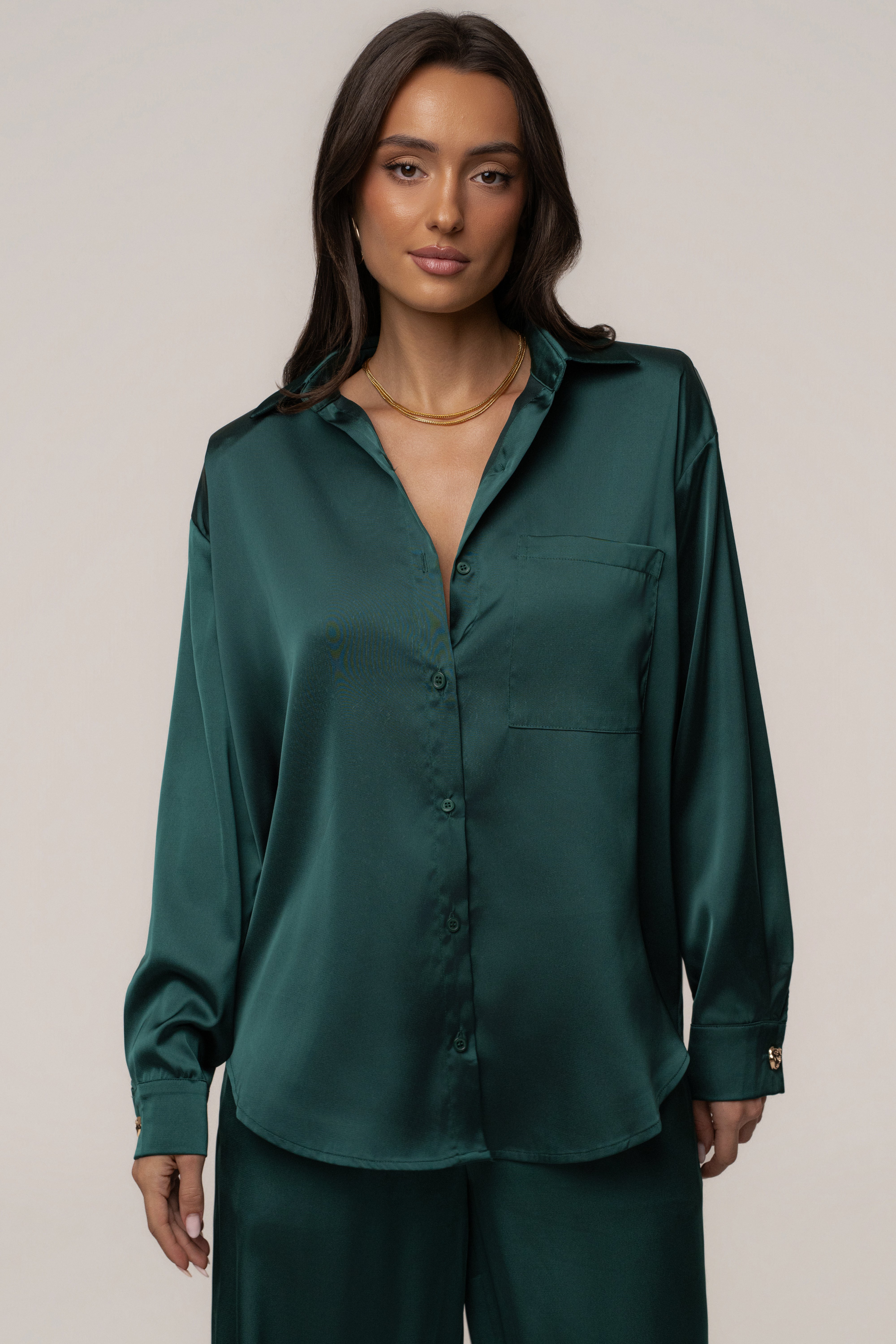 Emerald Island Ease collared satin top by JLUXLABEL featuring a sleek design and satin fabric, shown in a stylish close-up image.