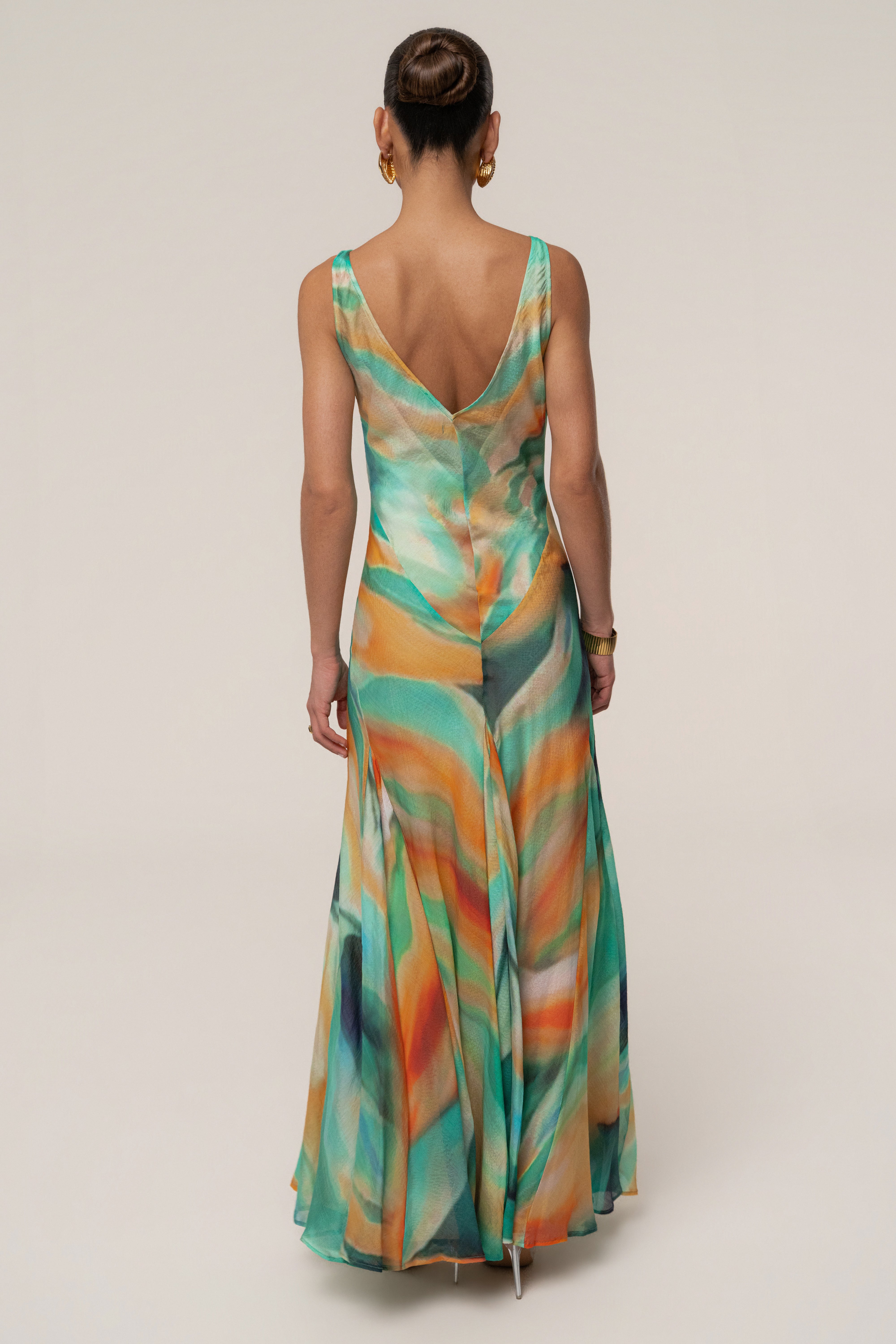 Green Prism Tide maxi dress by JLUXLABEL featuring a flowing silhouette, vibrant prism pattern, and elegant sleeveless design.