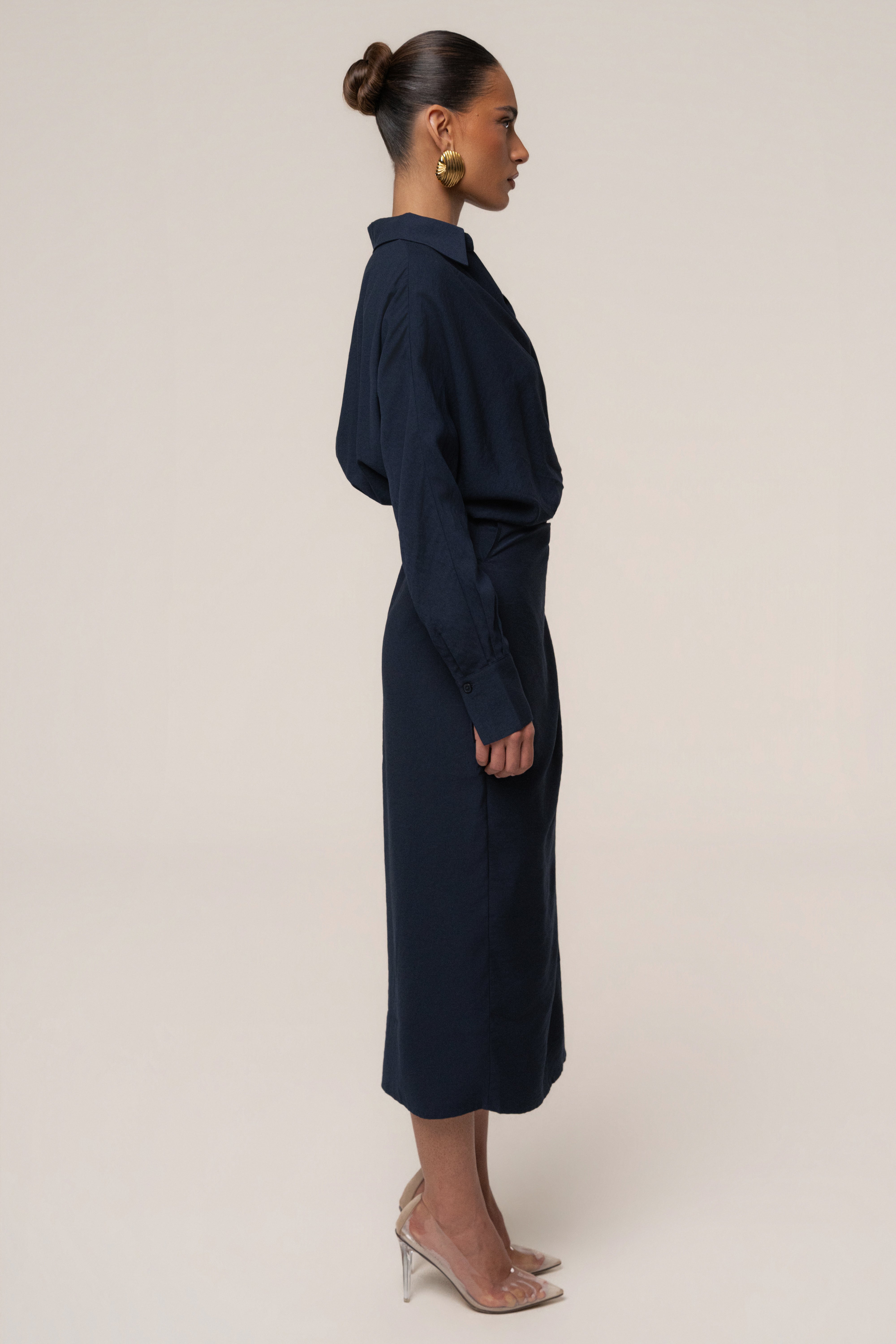 Navy Skyline Wrap Midi Dress by JLUXLABEL featuring a fitted waist, long sleeves, and a flowing skirt for elegant style.