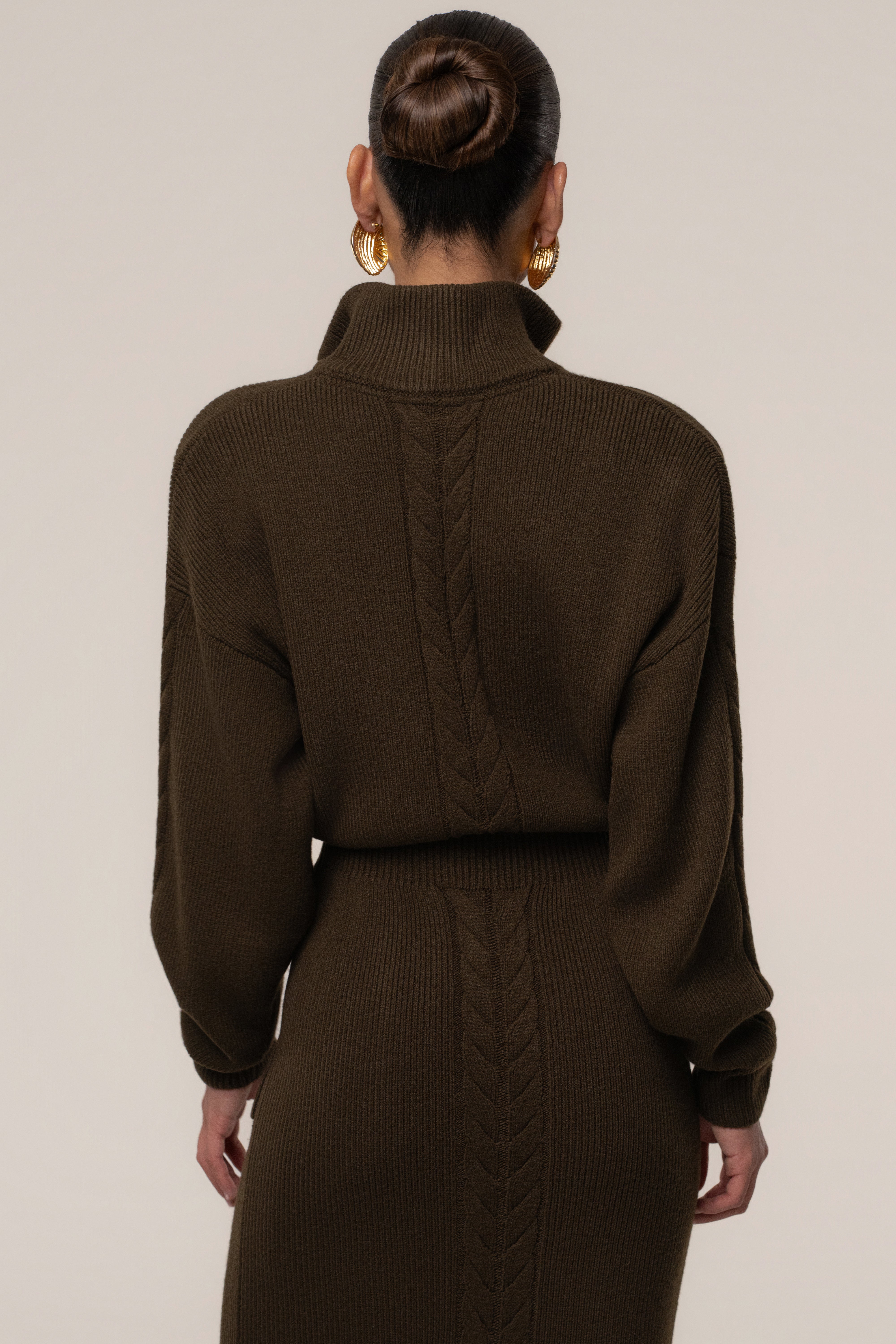 Chocolate JLUXLABEL Ribbed Cozy Intentions Dress displayed on a hanger with a fitted, ribbed design and long sleeves.