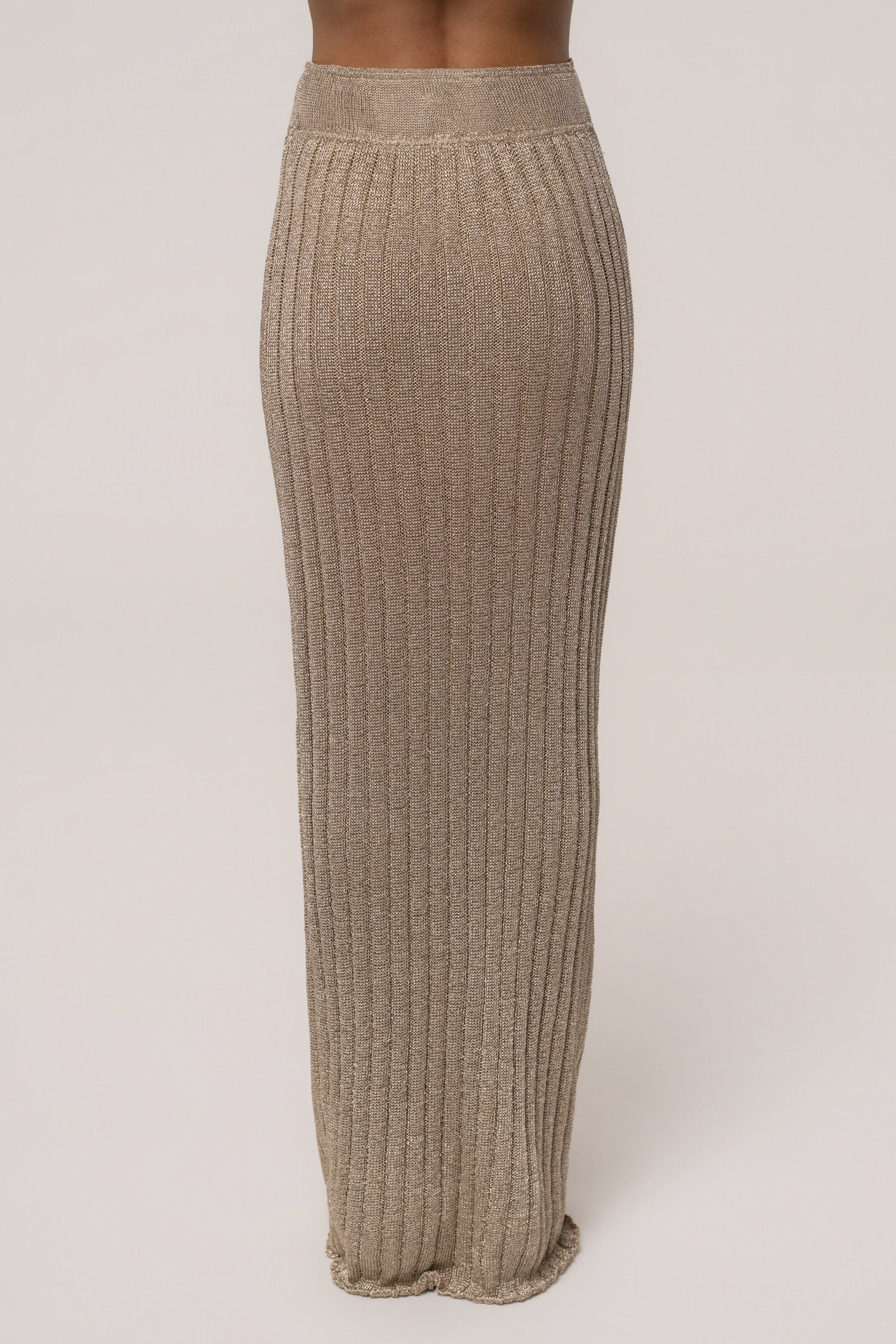 Gold metallic maxi skirt from JLUXLABEL featuring a flowing, elegant design perfect for resort wear.