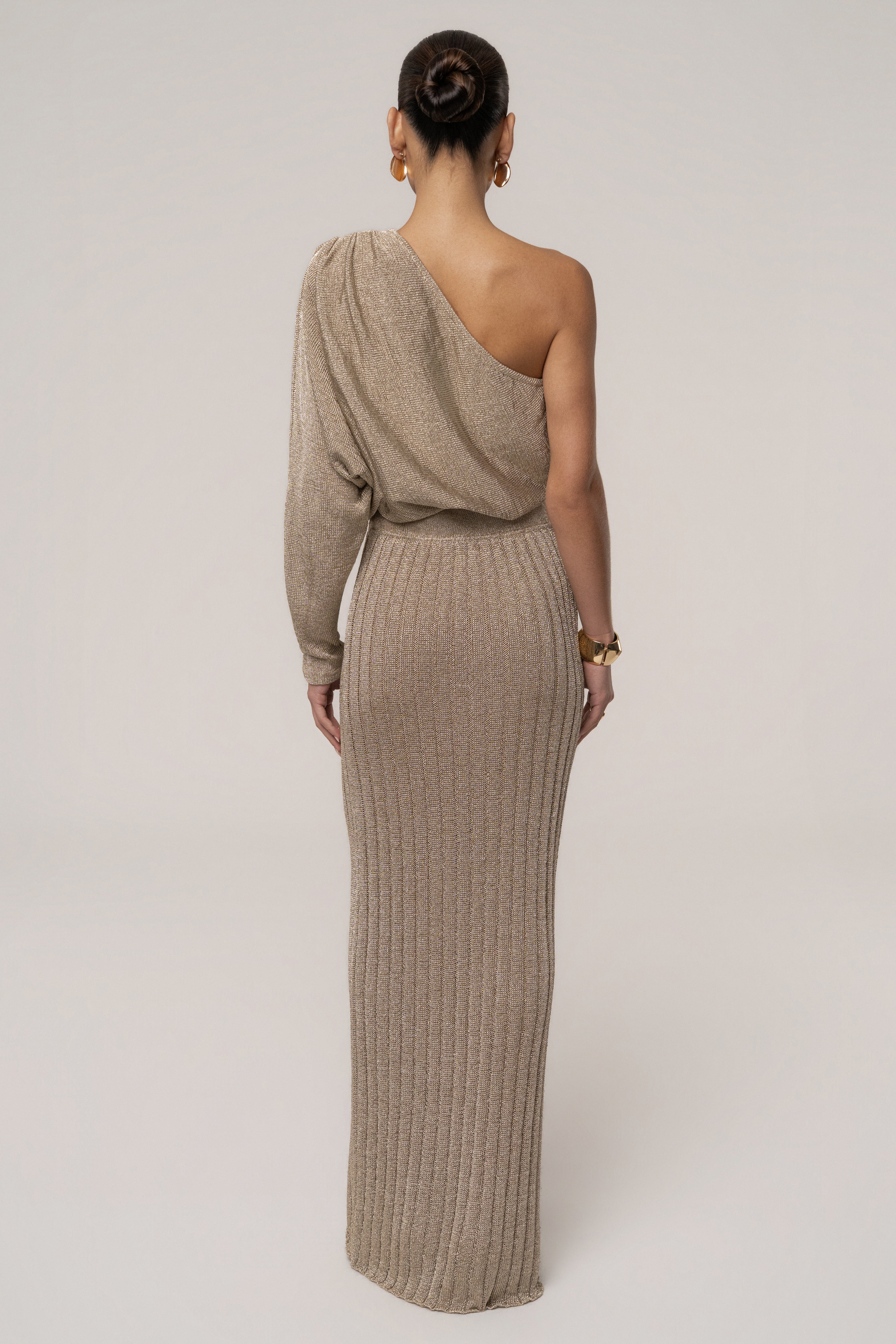 Gold metallic bodysuit from JLUXLABEL featuring a shiny, fitted top with long sleeves and a high neckline.