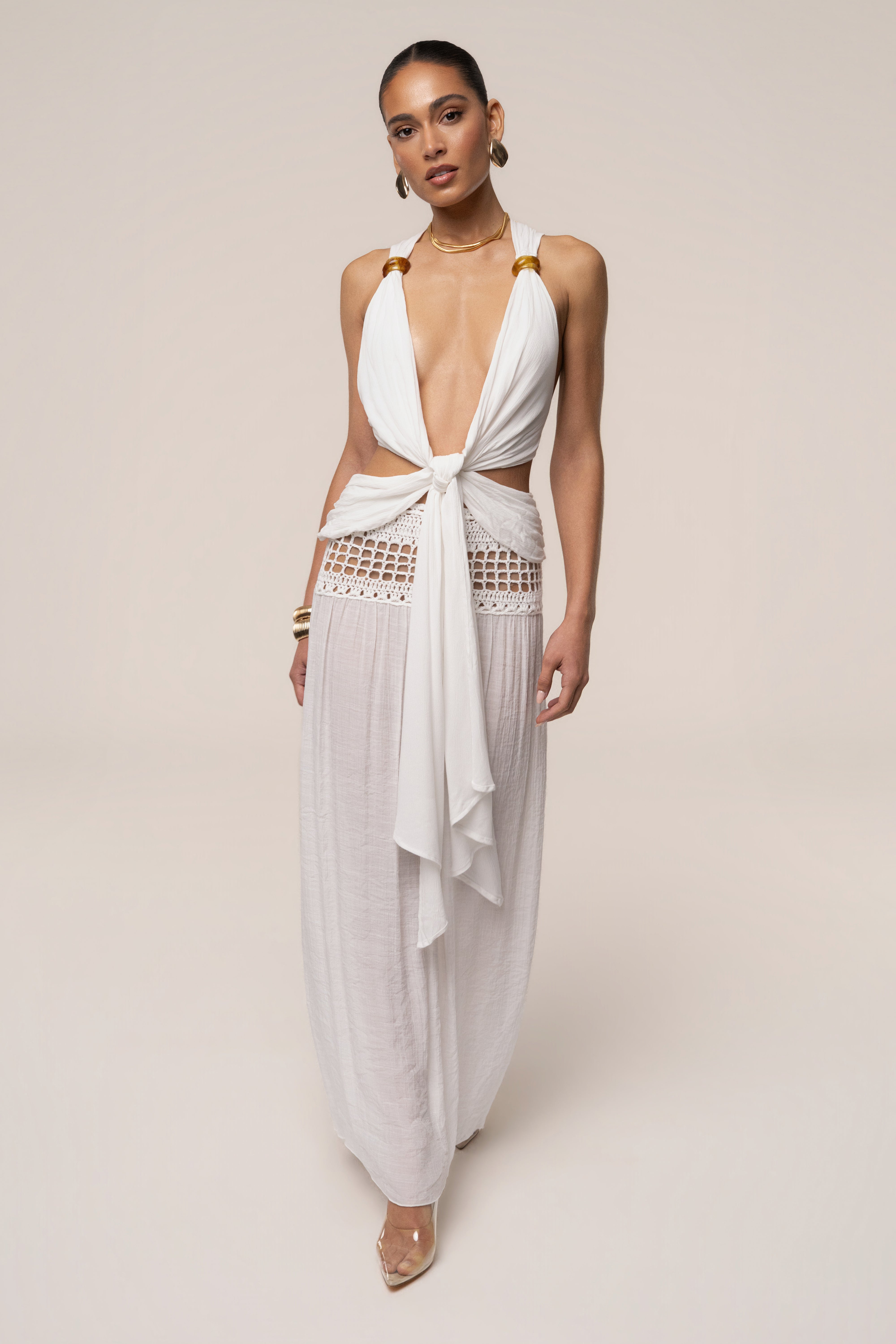 White Tulum Drape Top by JLUXLABEL, featuring a flowy fabric and draped design, displayed on a hanger.