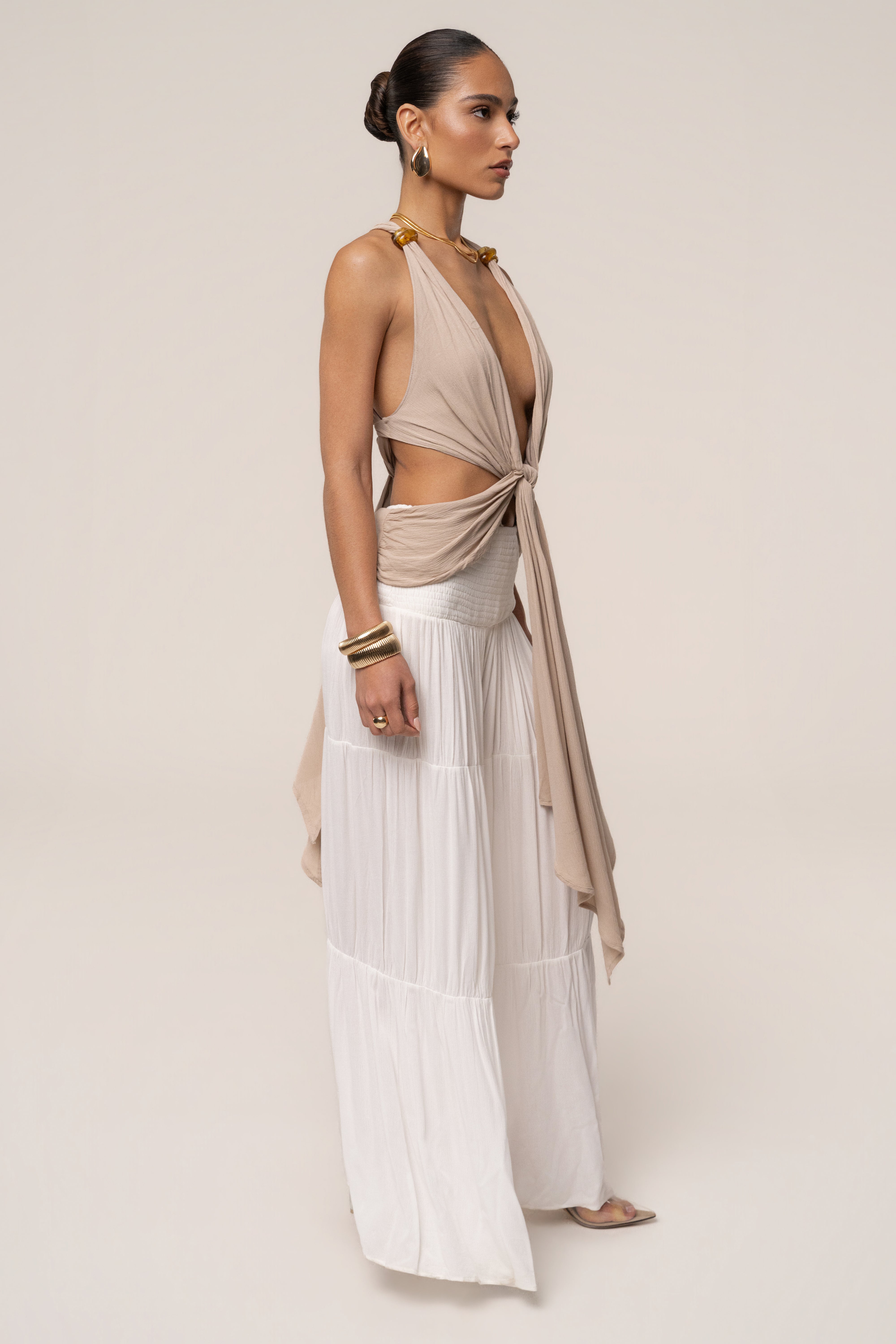 Beige Tulum Drape Top from JLUXLABEL, featuring soft fabric and relaxed fit, displayed on a hanger.