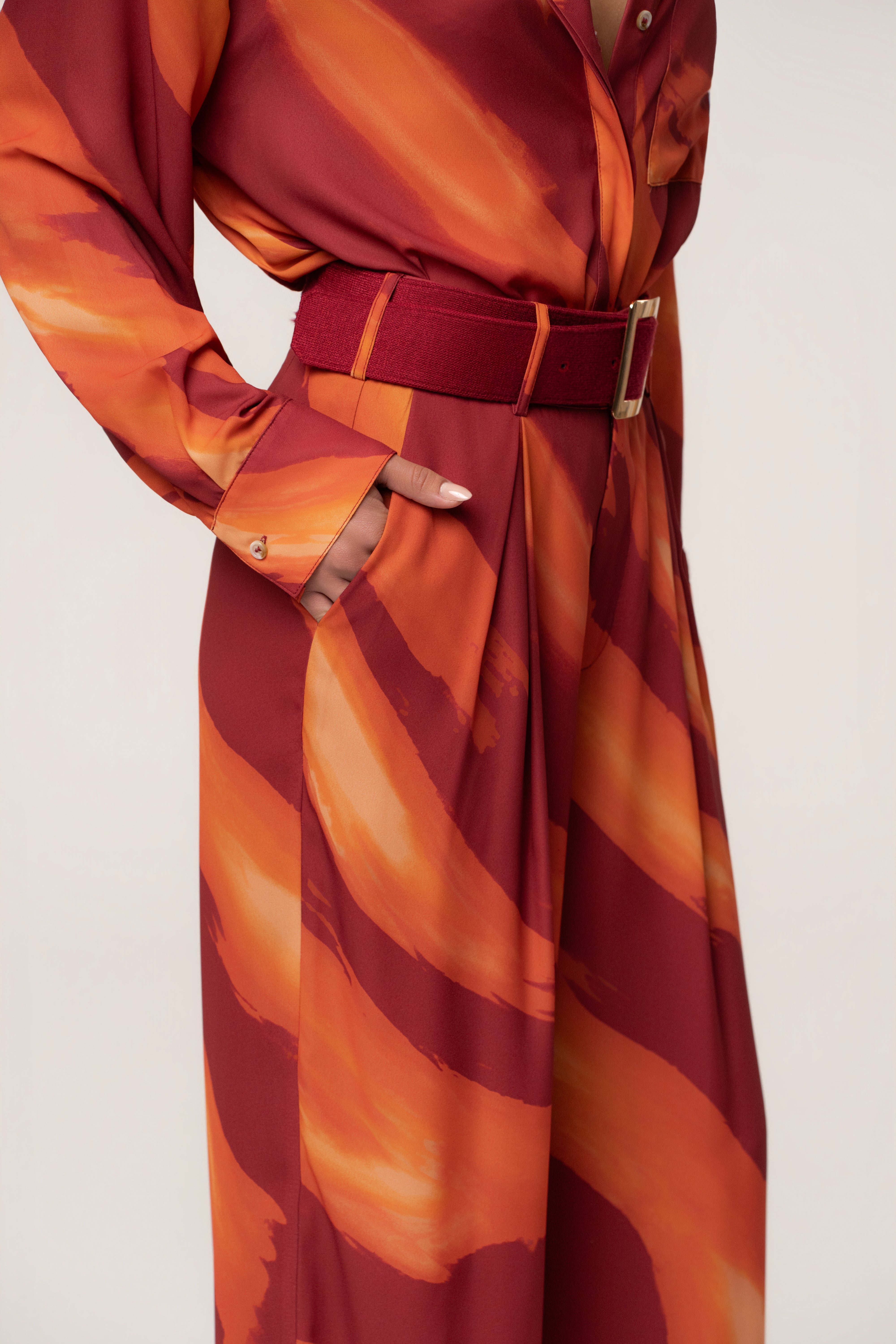 Crimson Dusk soft pleated trousers by JLUXLABEL, stylish bottoms with a relaxed fit and elegant pleats, shown on a model.