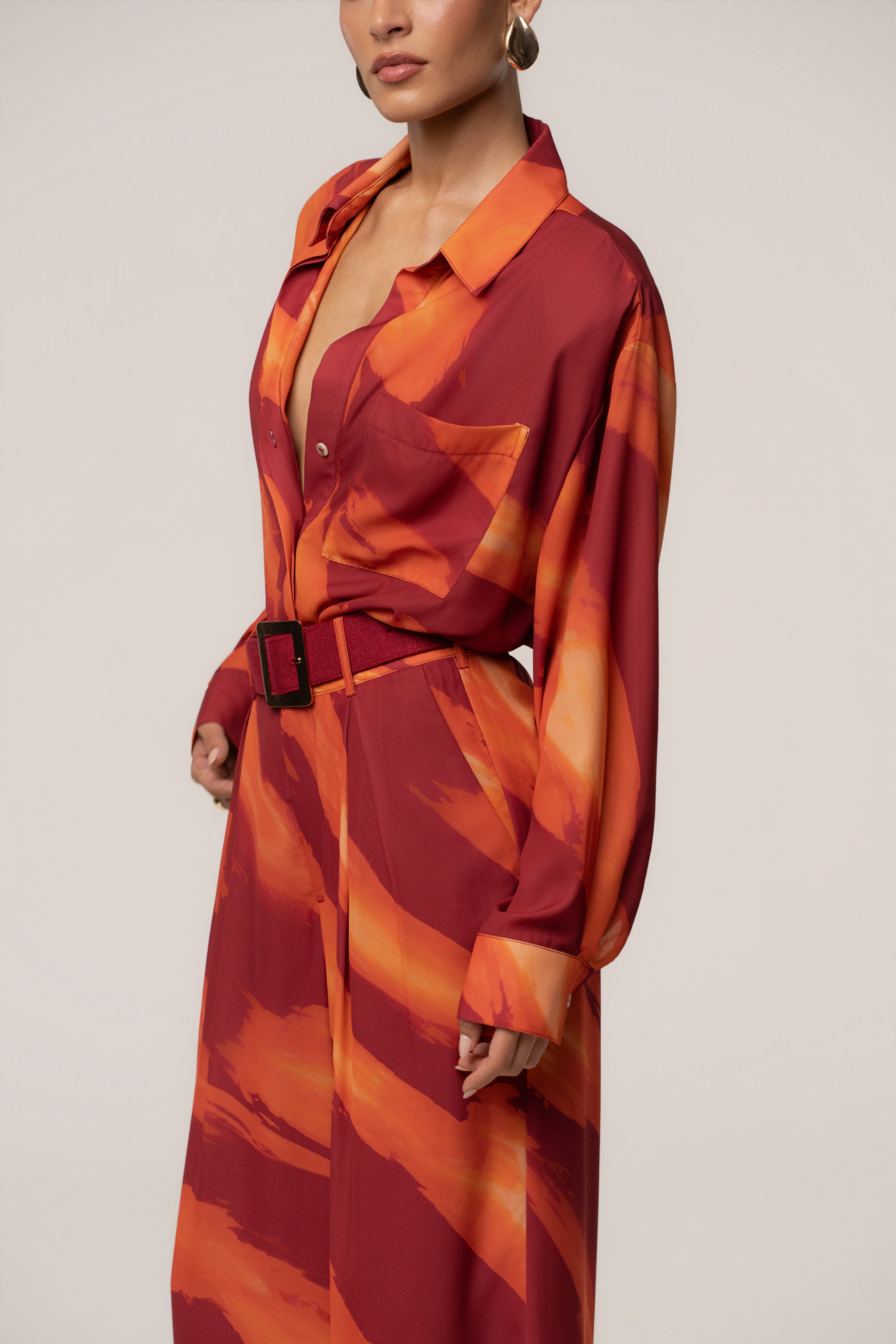 Crimson Dusk JLUXLABEL soft pleated trousers displayed flat, showcasing the stylish waistband and tailored pleats for women's bottoms.