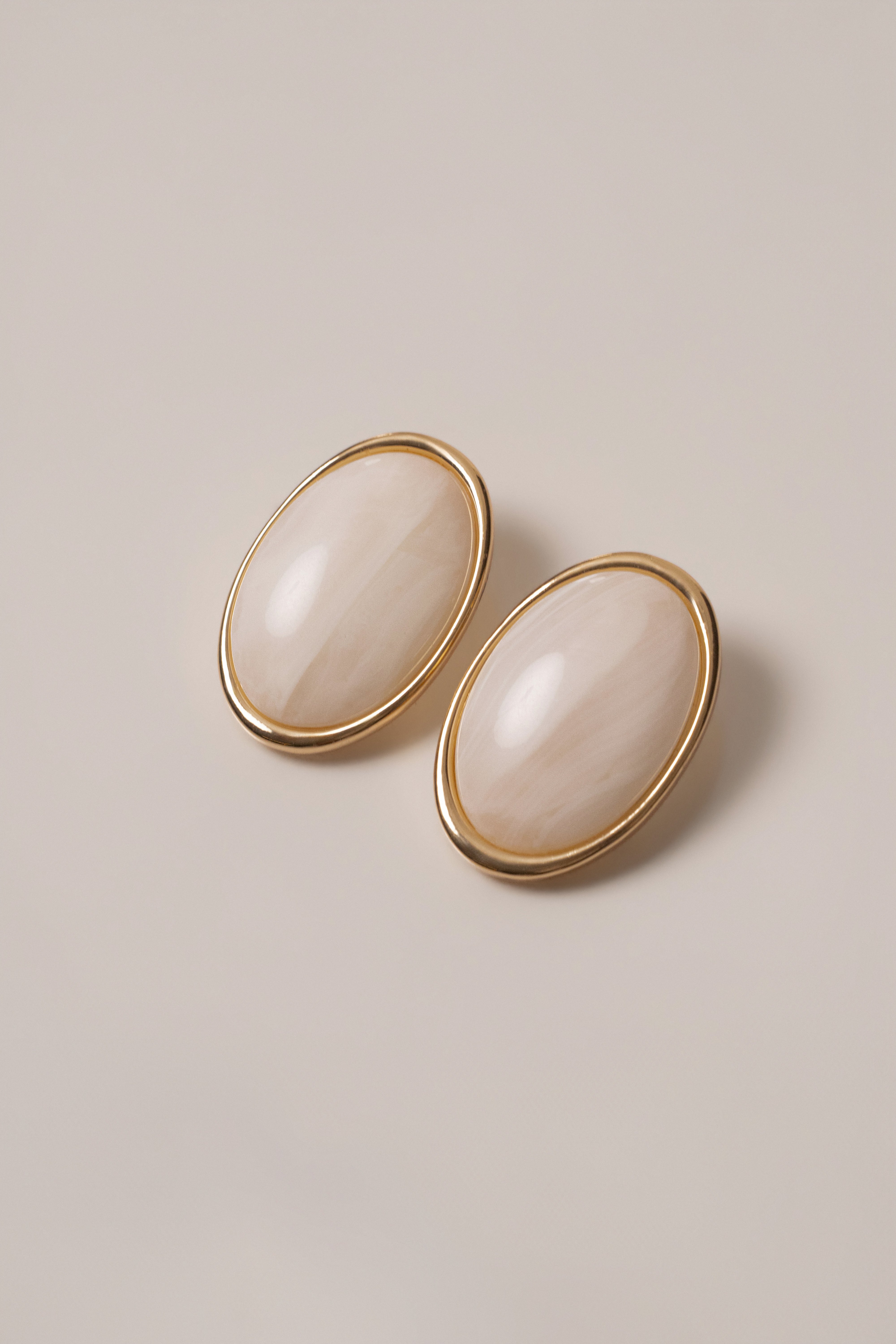 Ivory Alessia oval earrings by JLUXLABEL, elegant jewelry with smooth oval design and gold accents, displayed on a neutral background.