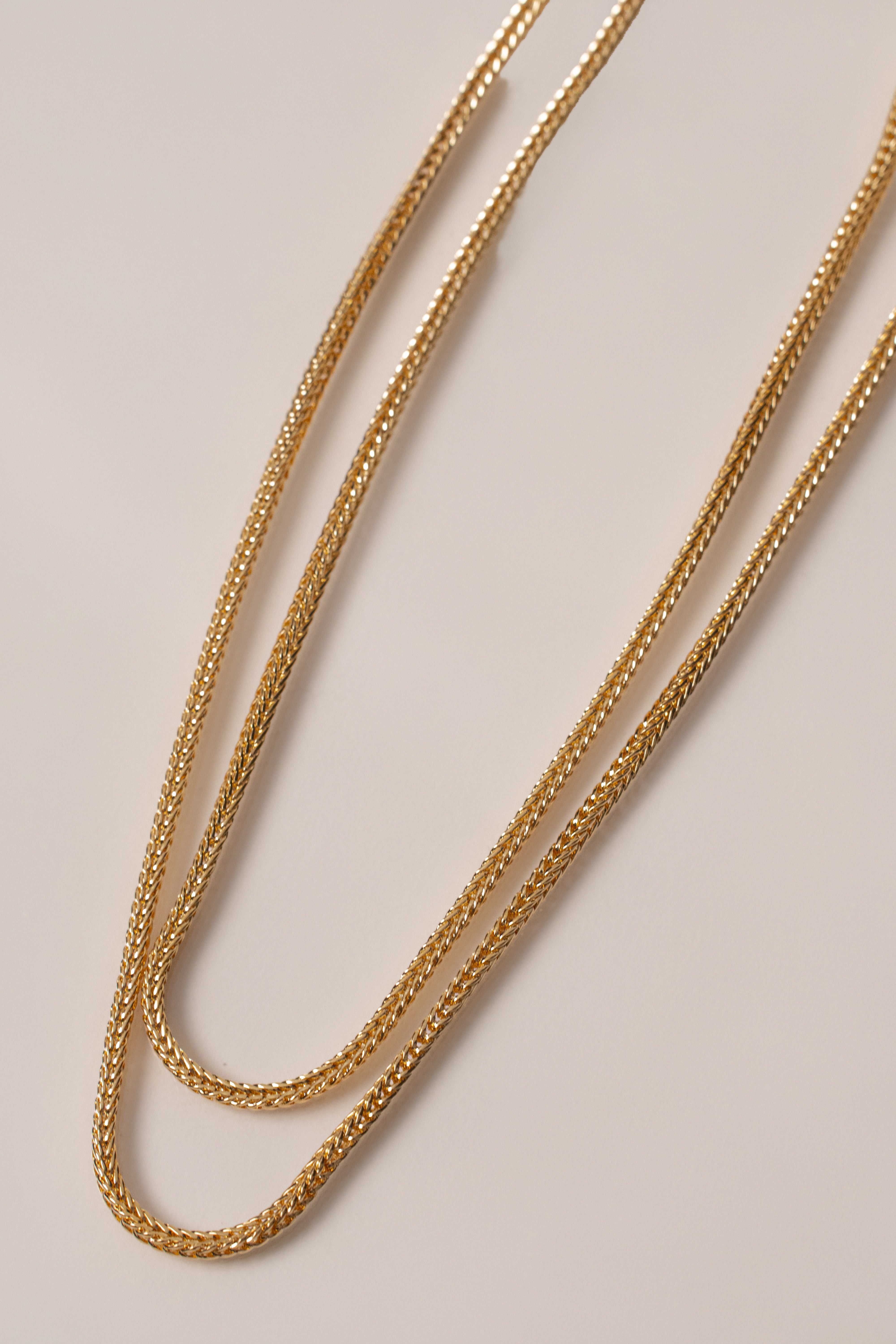 Gold double herringbone necklace from JLUXLABEL featuring sleek, layered chain design for elegant jewelry styling.