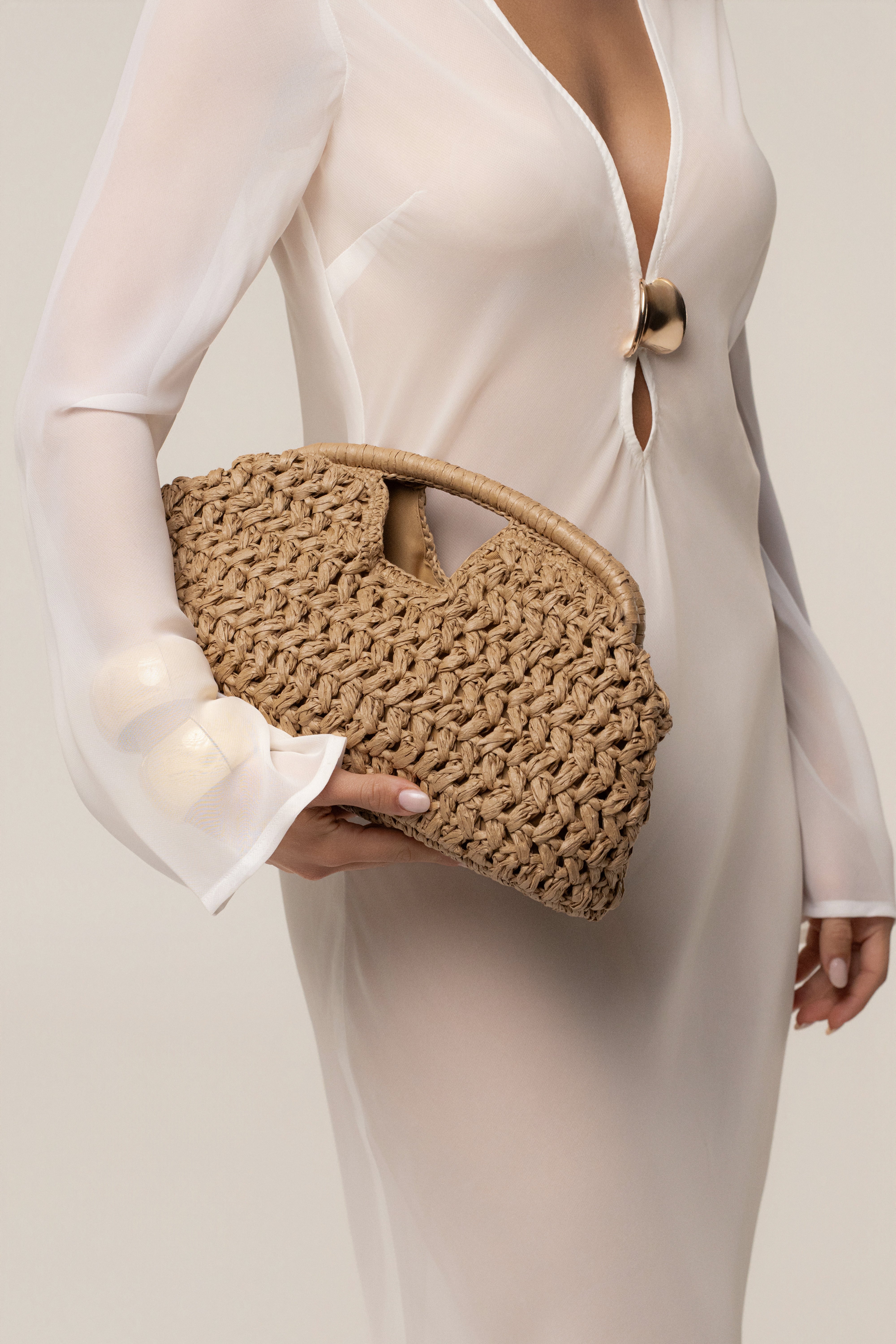 Natural Casa Sol straw bag by JLUXLABEL, woven accessory with leather handles, perfect for casual summer outings.