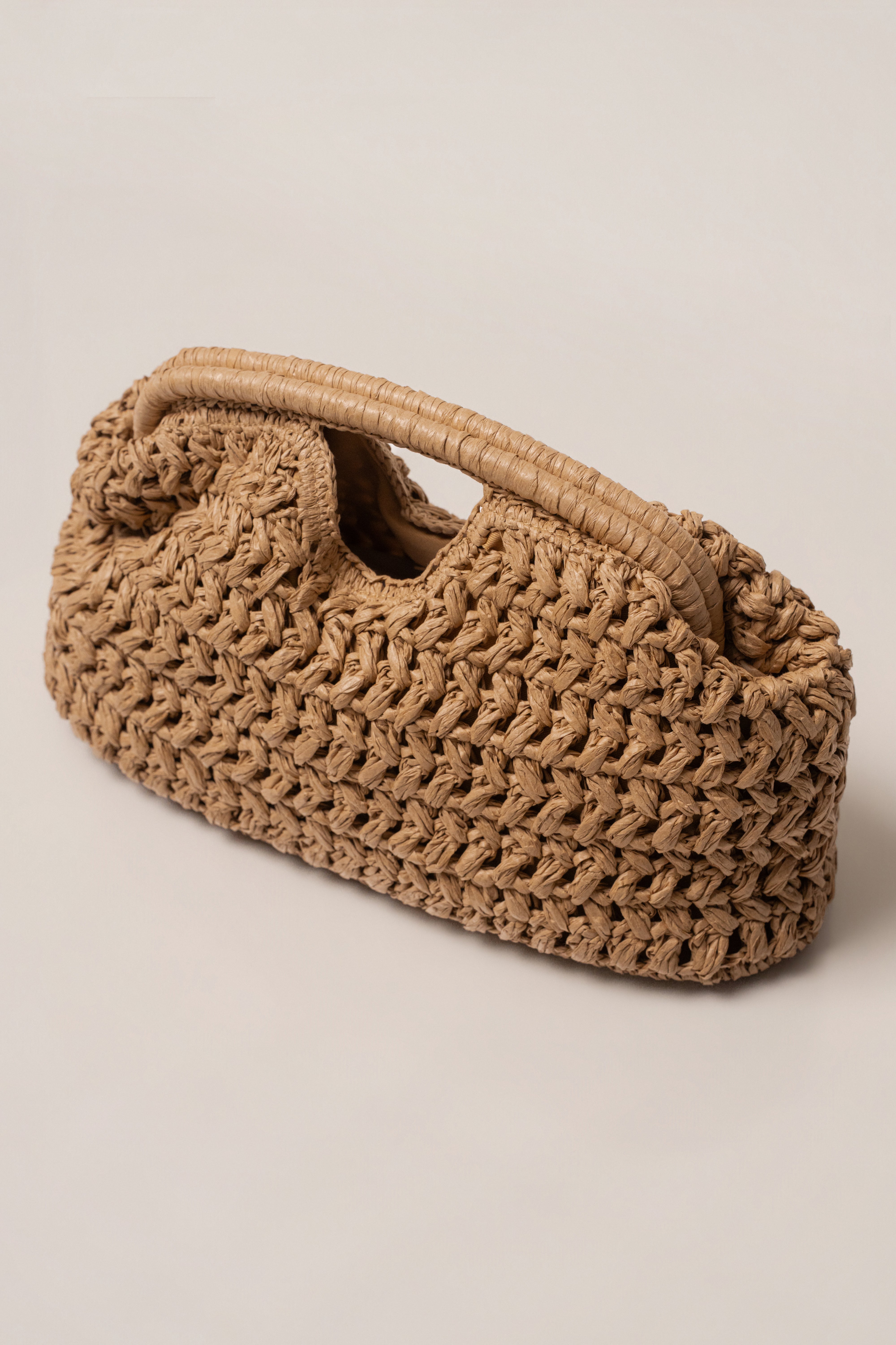 Natural Casa Sol straw bag by JLUXLABEL, showing woven straw accessory with handles, perfect for casual or summer outfits.