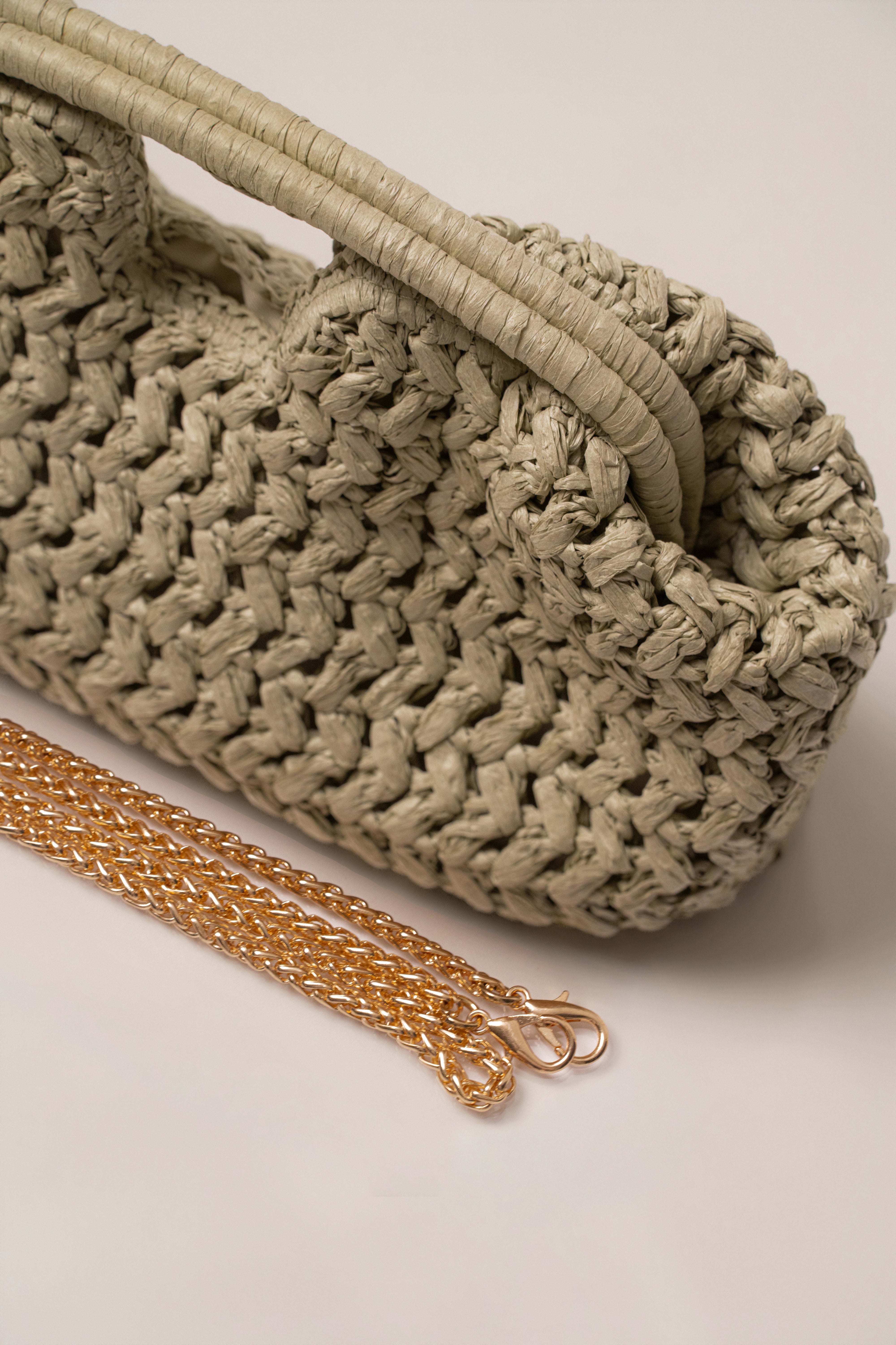 JLUXLABEL Sage Casa Sol straw bag accessory with woven design and adjustable shoulder strap, perfect for casual outings.