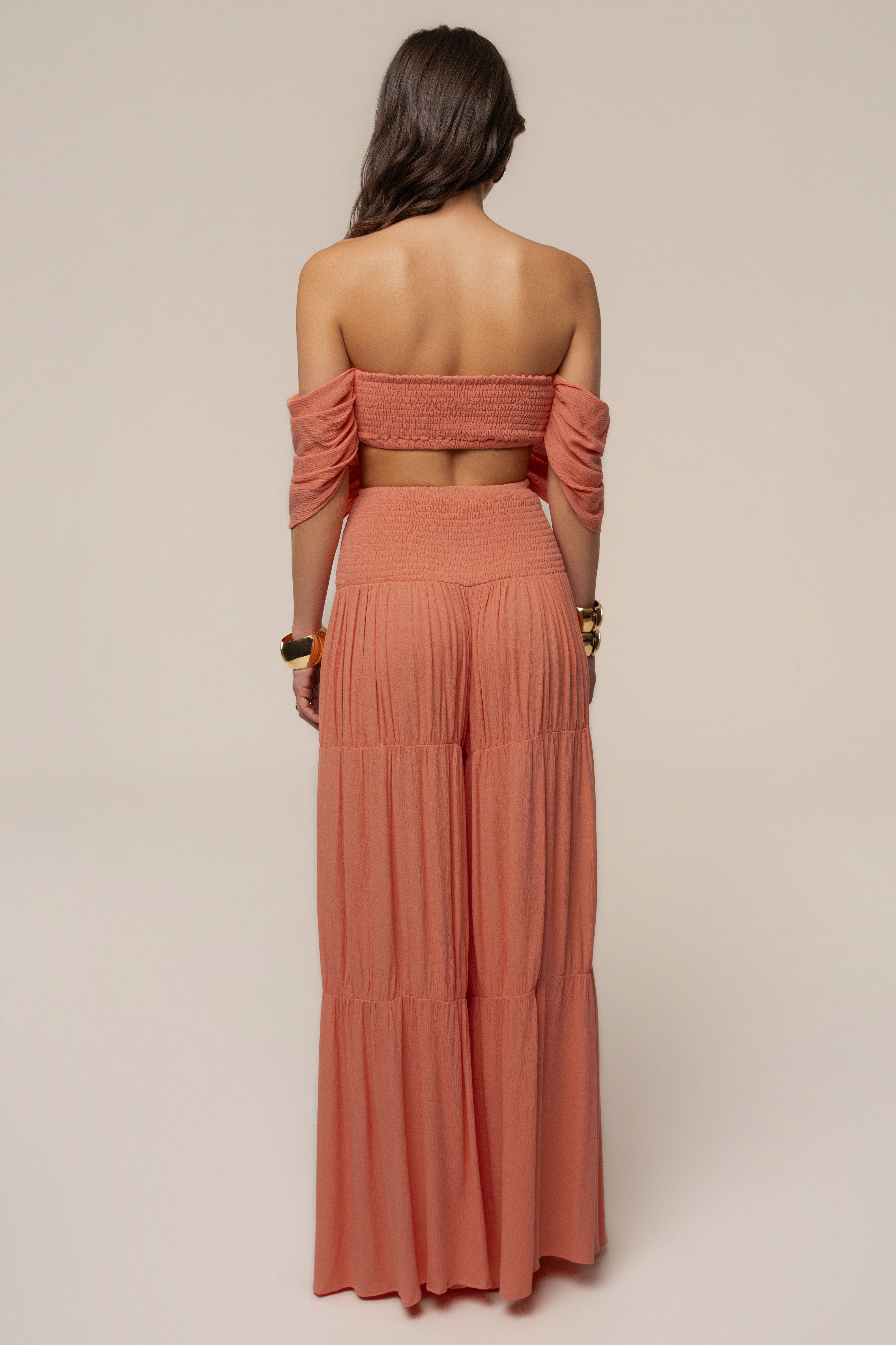 Peach Hidden Gems tier pant set by JLUXLABEL featuring layered tiered pants and a matching top on a model.