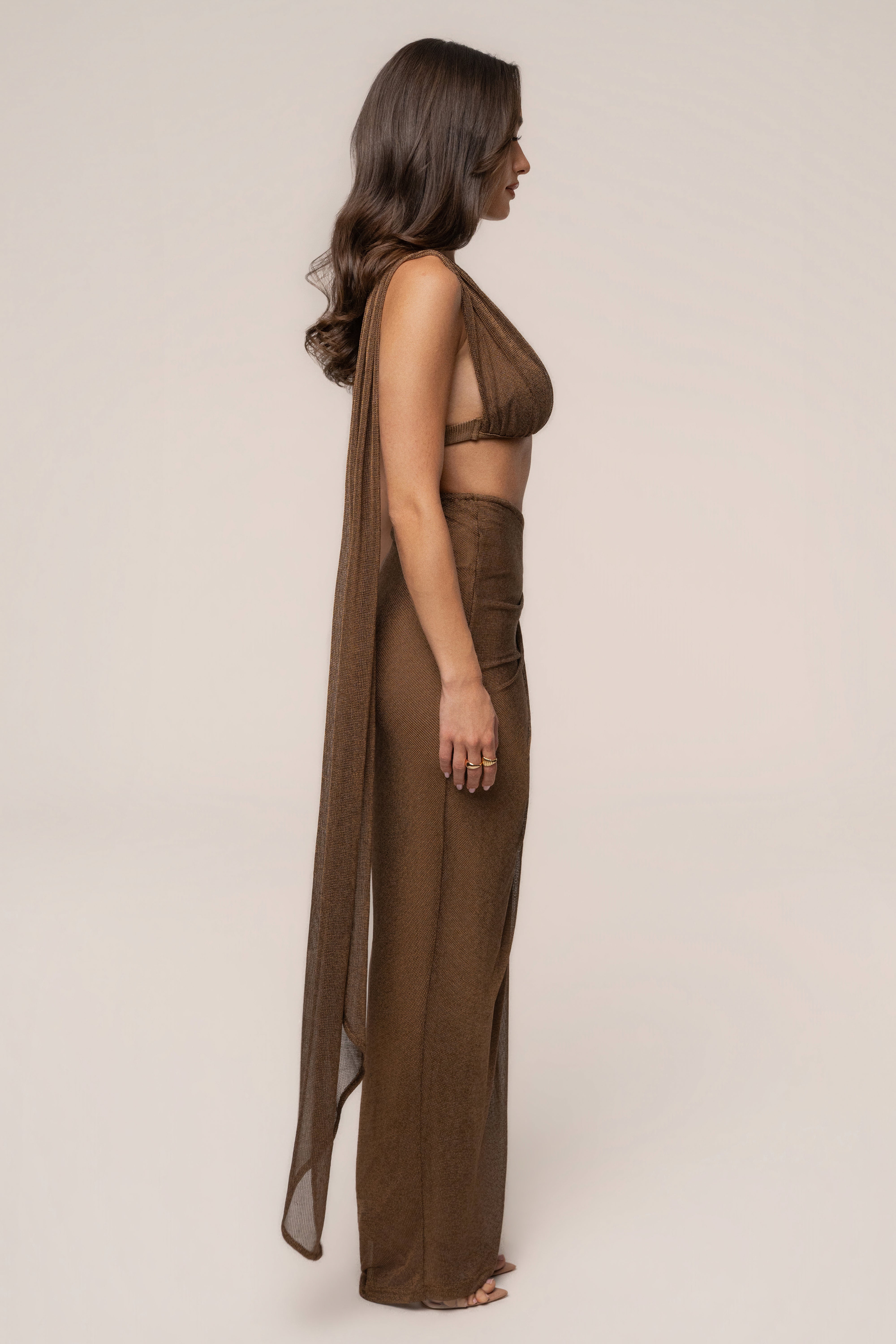 Bronze Noelia metallic slit skirt by JLUXLABEL, featuring a shiny metallic finish and stylish slit detail for a trendy look.