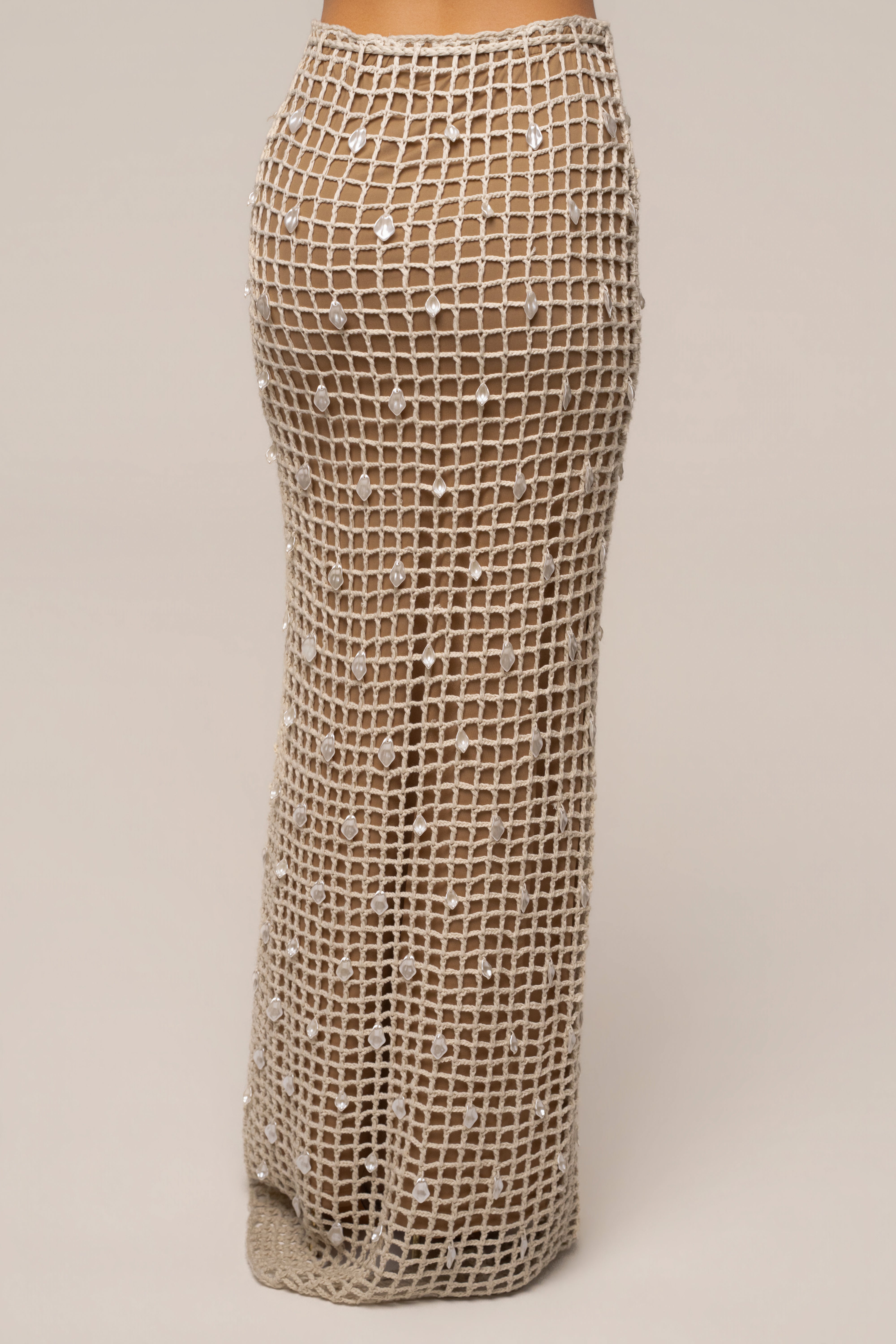 Ecru Pearl Shore crochet skirt by JLUXLABEL, featuring intricate crochet design and pearl accents, styled as a trendy women's bottom.