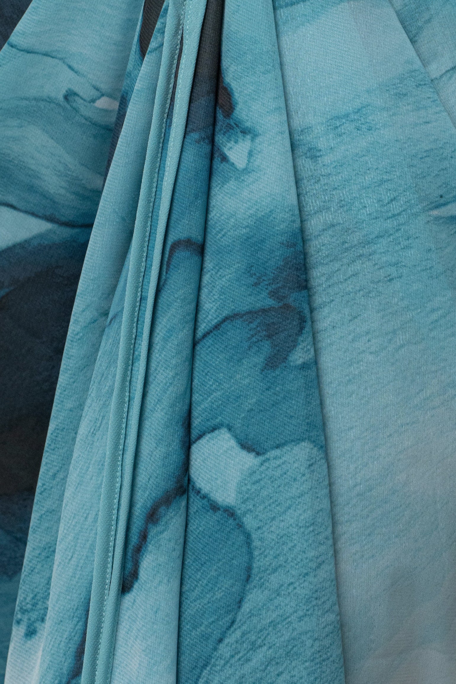 Blue abstract printed duster outerwear from JLUXLABEL with flowing fabric and stylish design, displayed on a hanger.