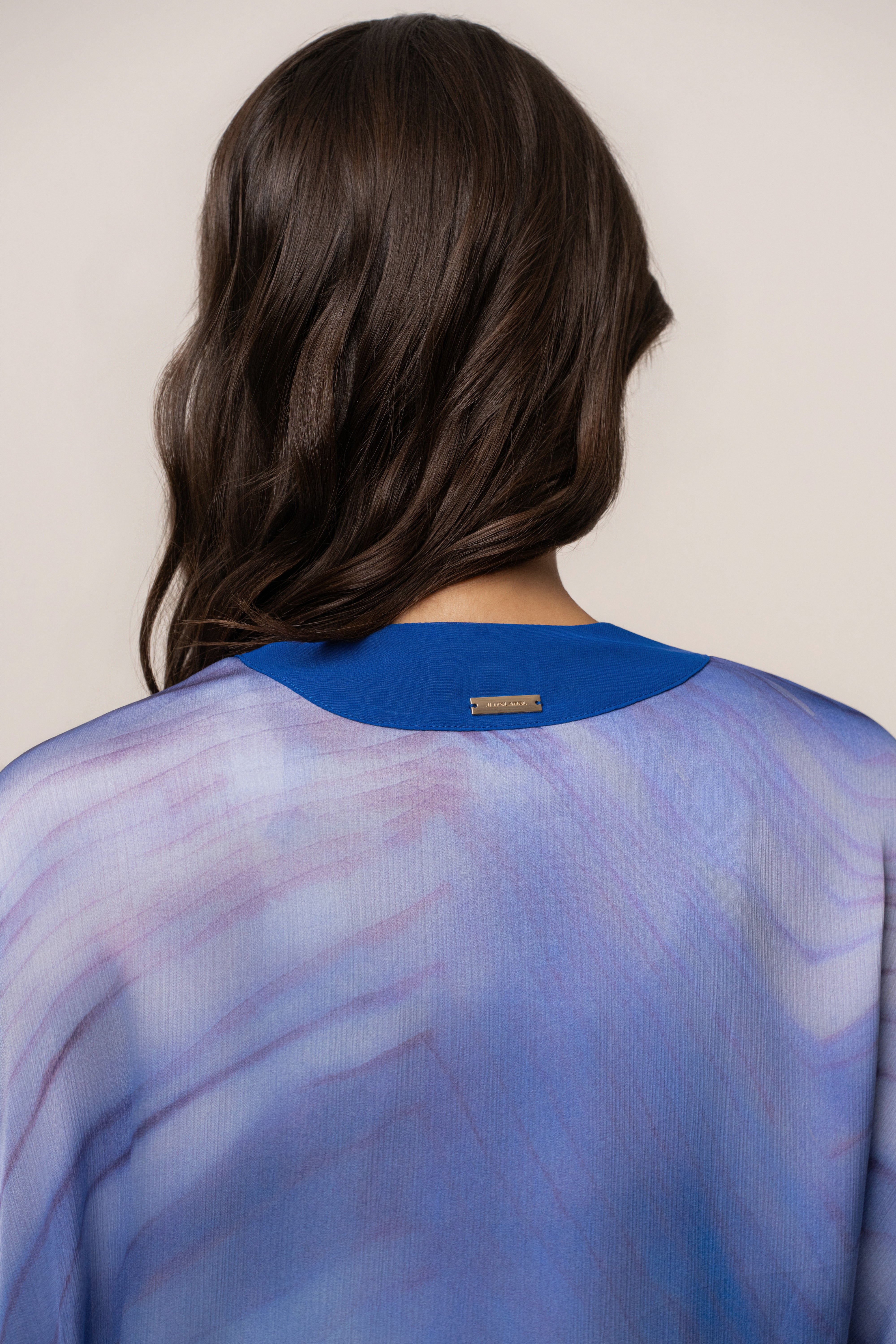 Blue Bahía satin duster from JLUXLABEL, lightweight outerwear with a smooth satin finish and flowing silhouette.