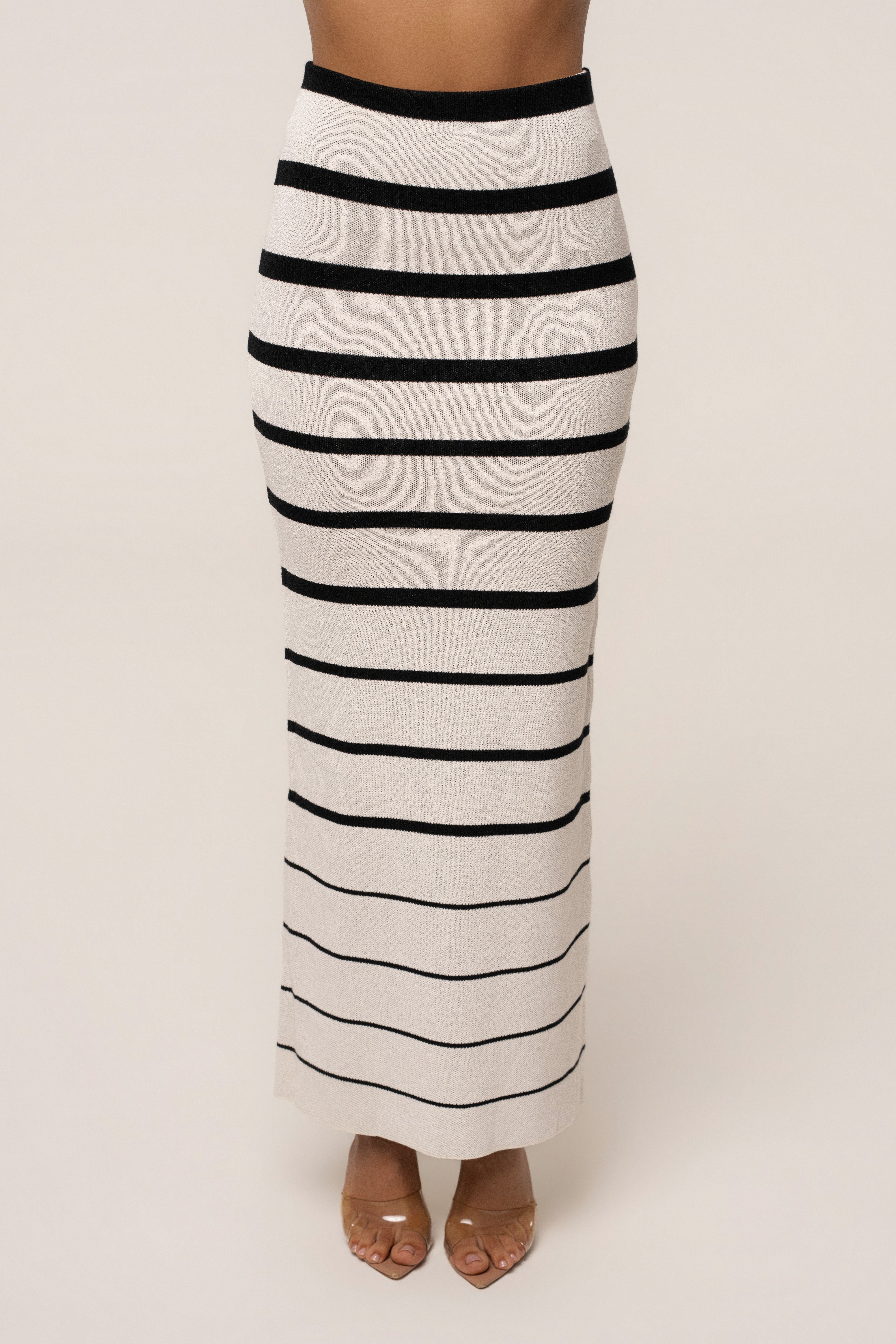 White and black striped Marina Nights skirt set by JLUXLABEL, featuring a stylish two-piece with a fitted top and matching skirt.