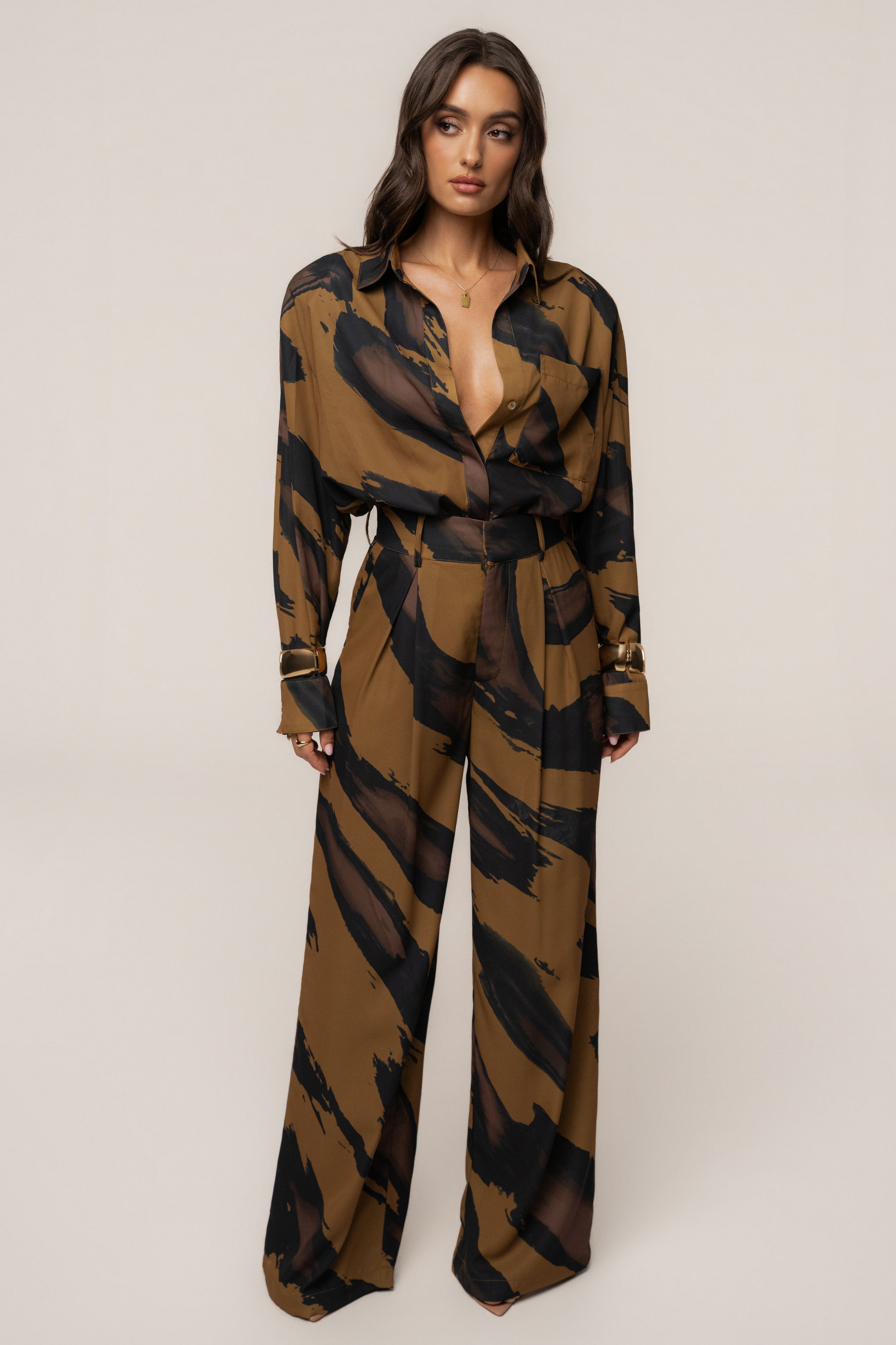 Gold Dusk soft pleated JLUXLABEL bottoms with relaxed fit and elegant pleats, styled as versatile women's trousers.