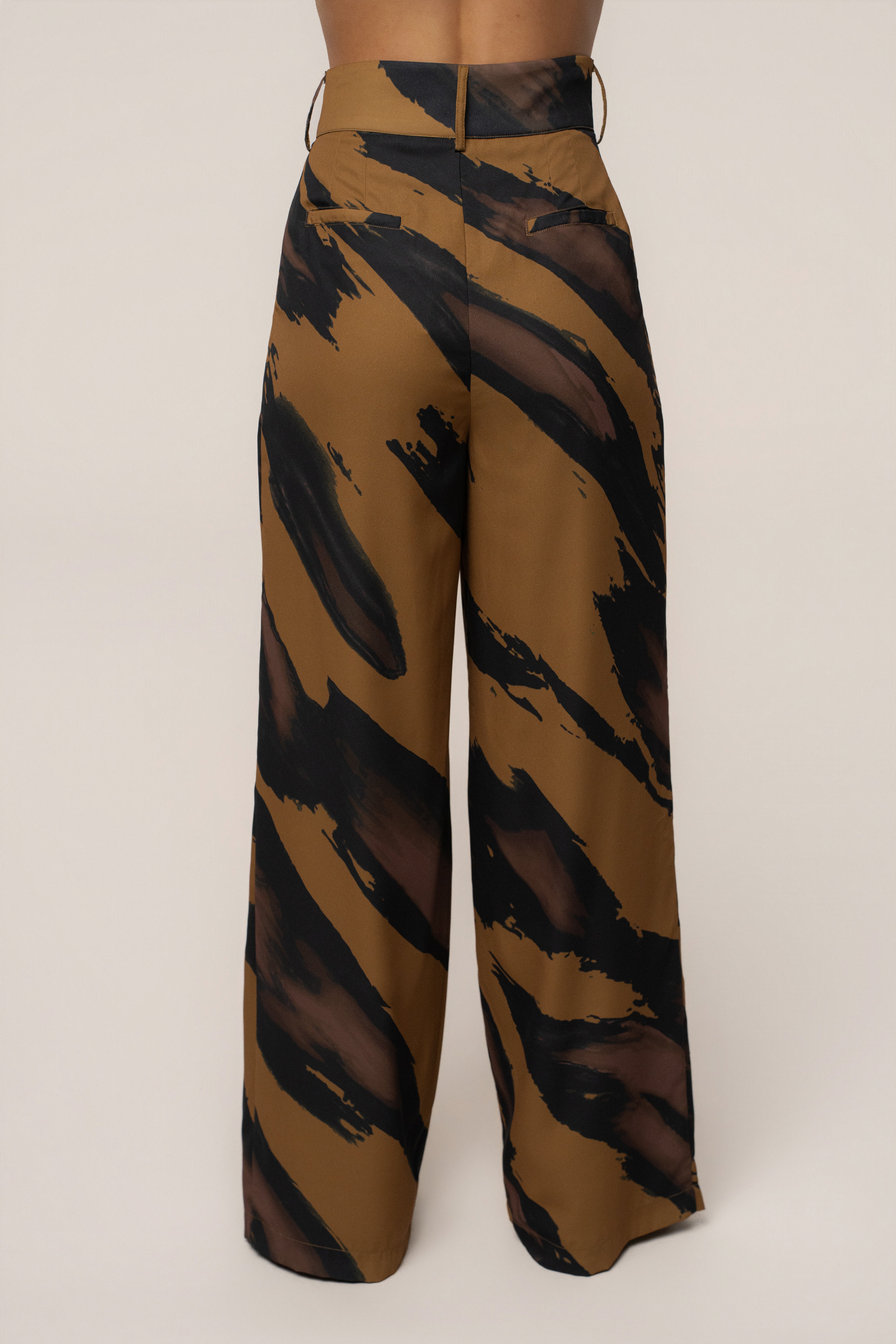Gold Dusk soft pleated JLUXLABEL bottoms featuring high-waisted, wide-leg trousers with elegant pleats and a relaxed fit.