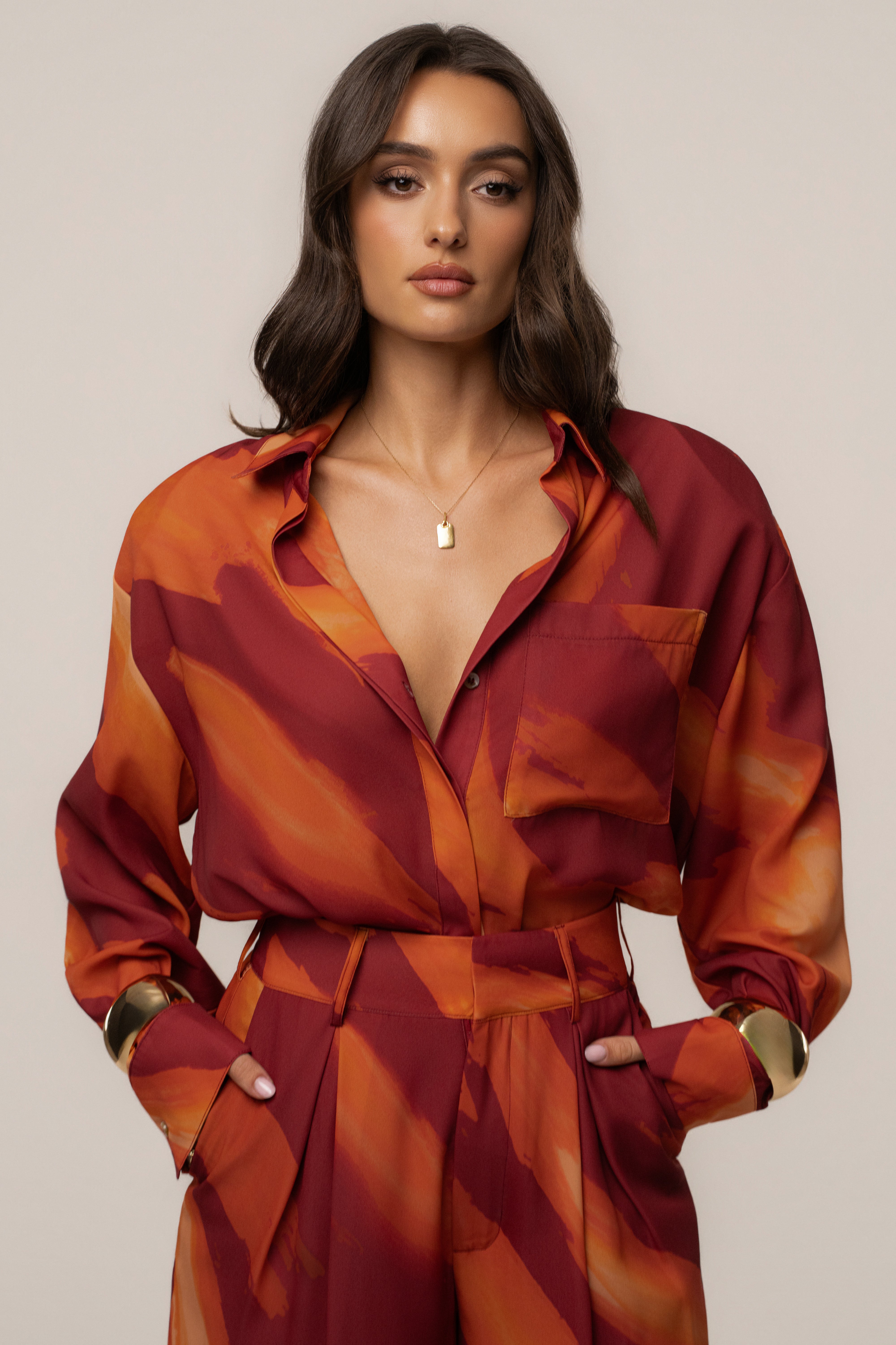 Crimson Dusk Fierce Form button-down shirt by JLUXLABEL, displayed on a hanger with a close-up of the fabric and collar details.