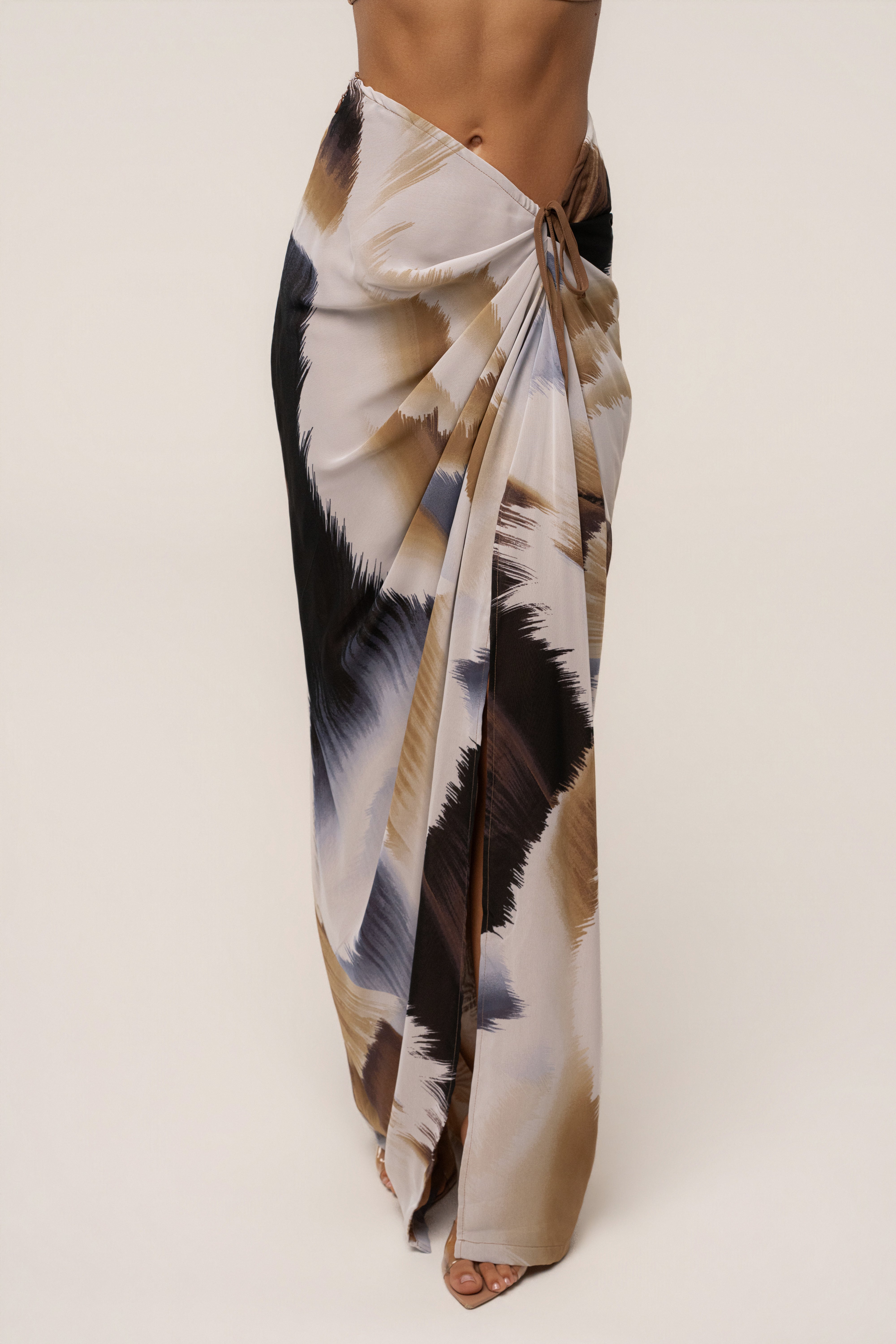 Brown abstract Noelia printed skirt from JLUXLABEL, stylish bottoms featuring a unique abstract pattern and flowy fabric.