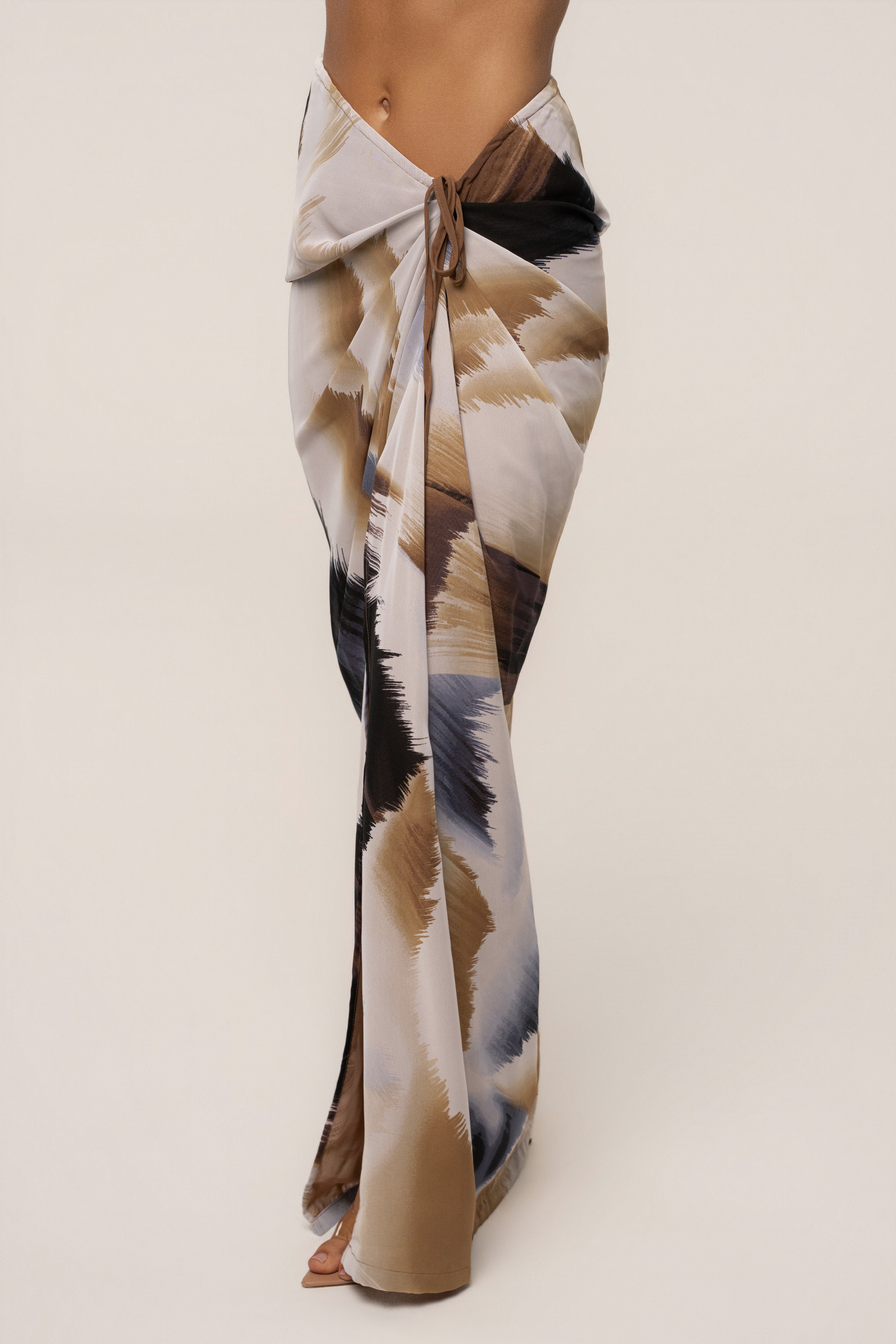 Brown abstract Noelia printed skirt by JLUXLABEL, showcasing a stylish flowy bottom with unique abstract pattern.
